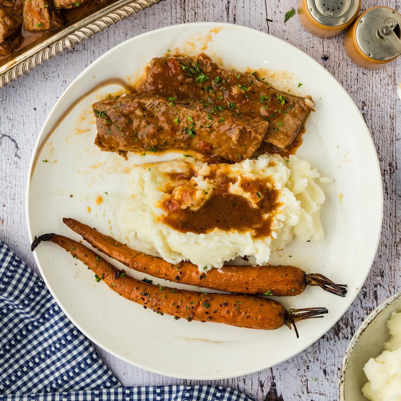beef brisket and gravy with mashed potatoes and carrots on late