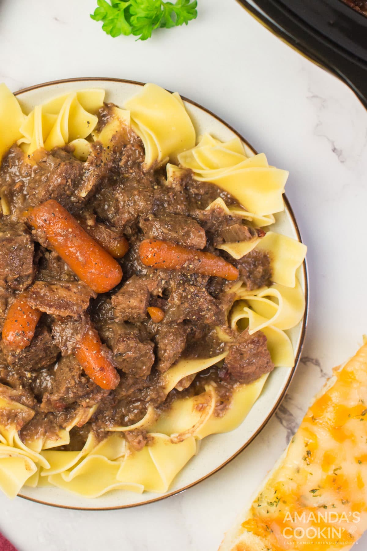 plate of beef burgundy on egg noodles