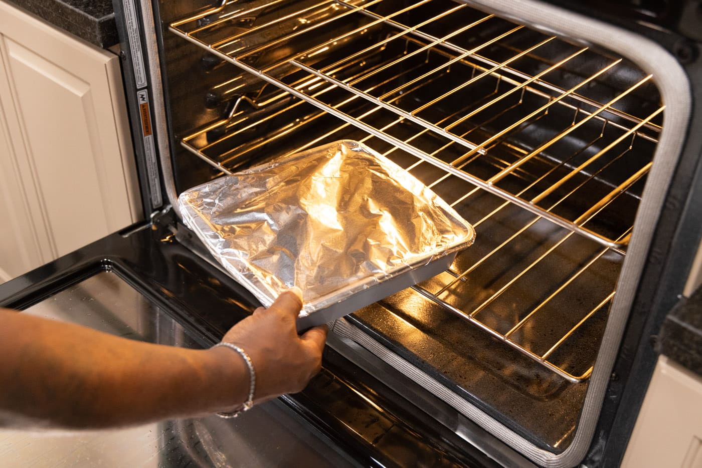putting short ribs in the oven covered with aluminum foil