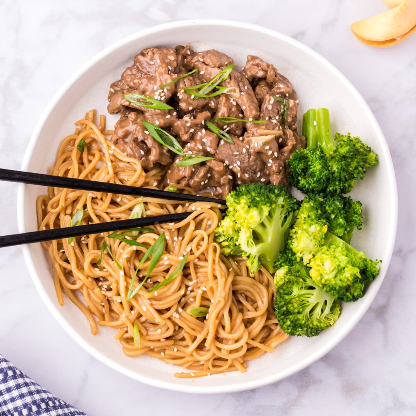 Beef Teriyaki on a plate served with teriyaki noodles and broccoli