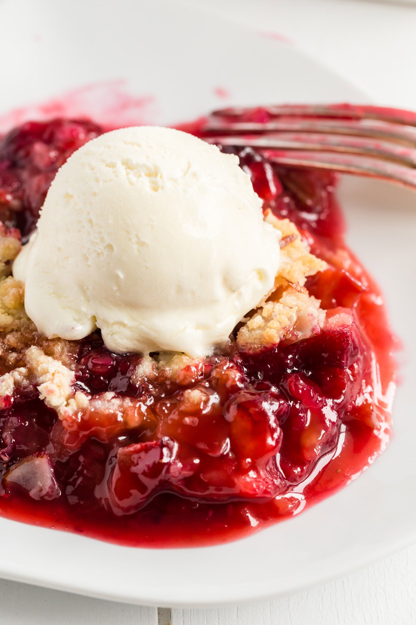 Close up photo of Prize Winning Rhubarb Crumble in a bowl topped with ice cream