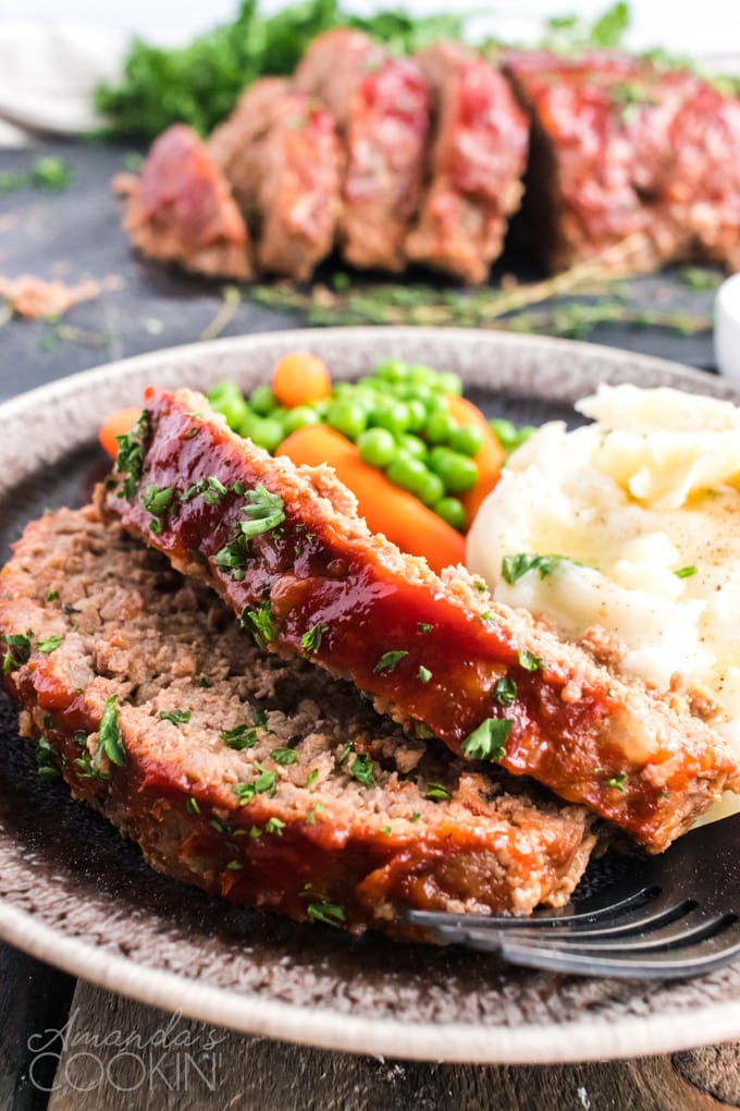 2 slices of meatloaf on a plate with mashed potatoes
