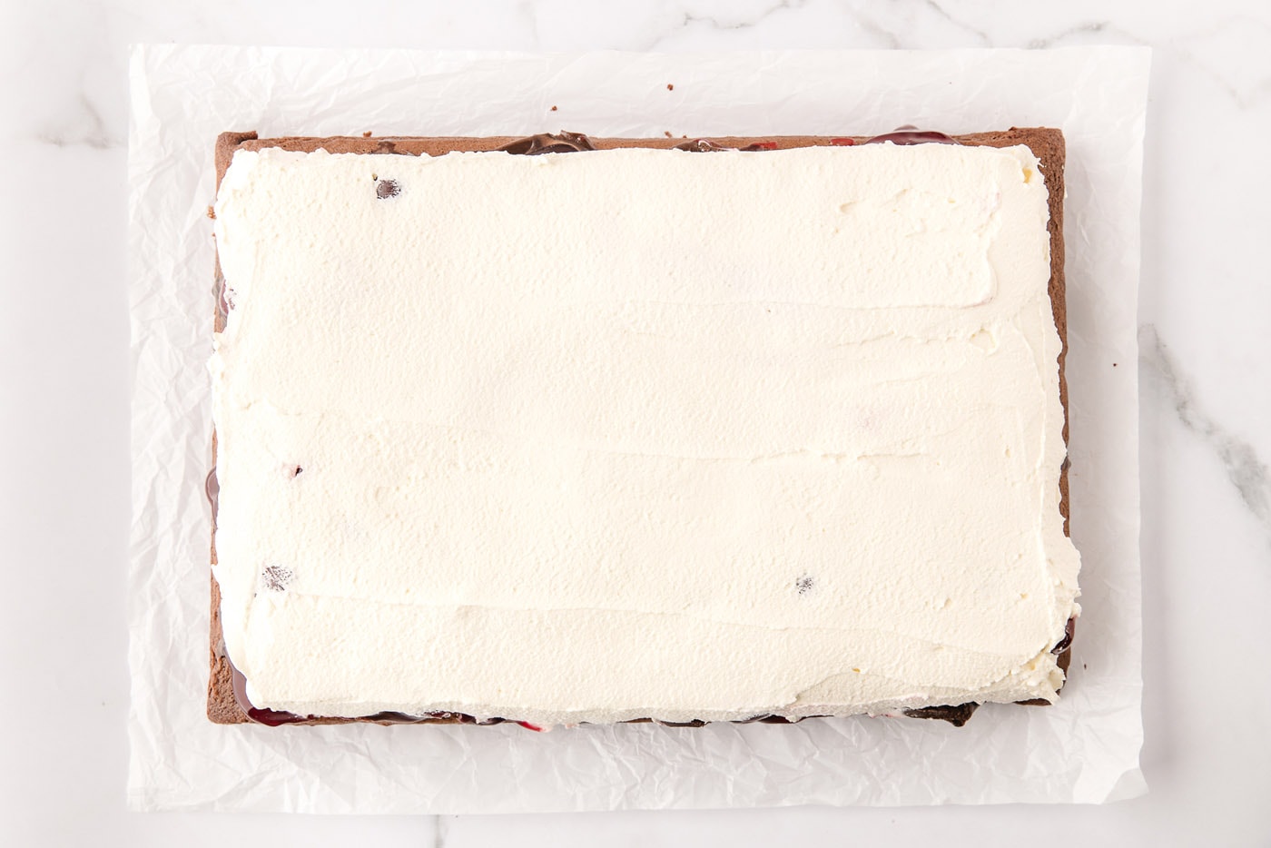 whipped cream topping on black forest poke cake