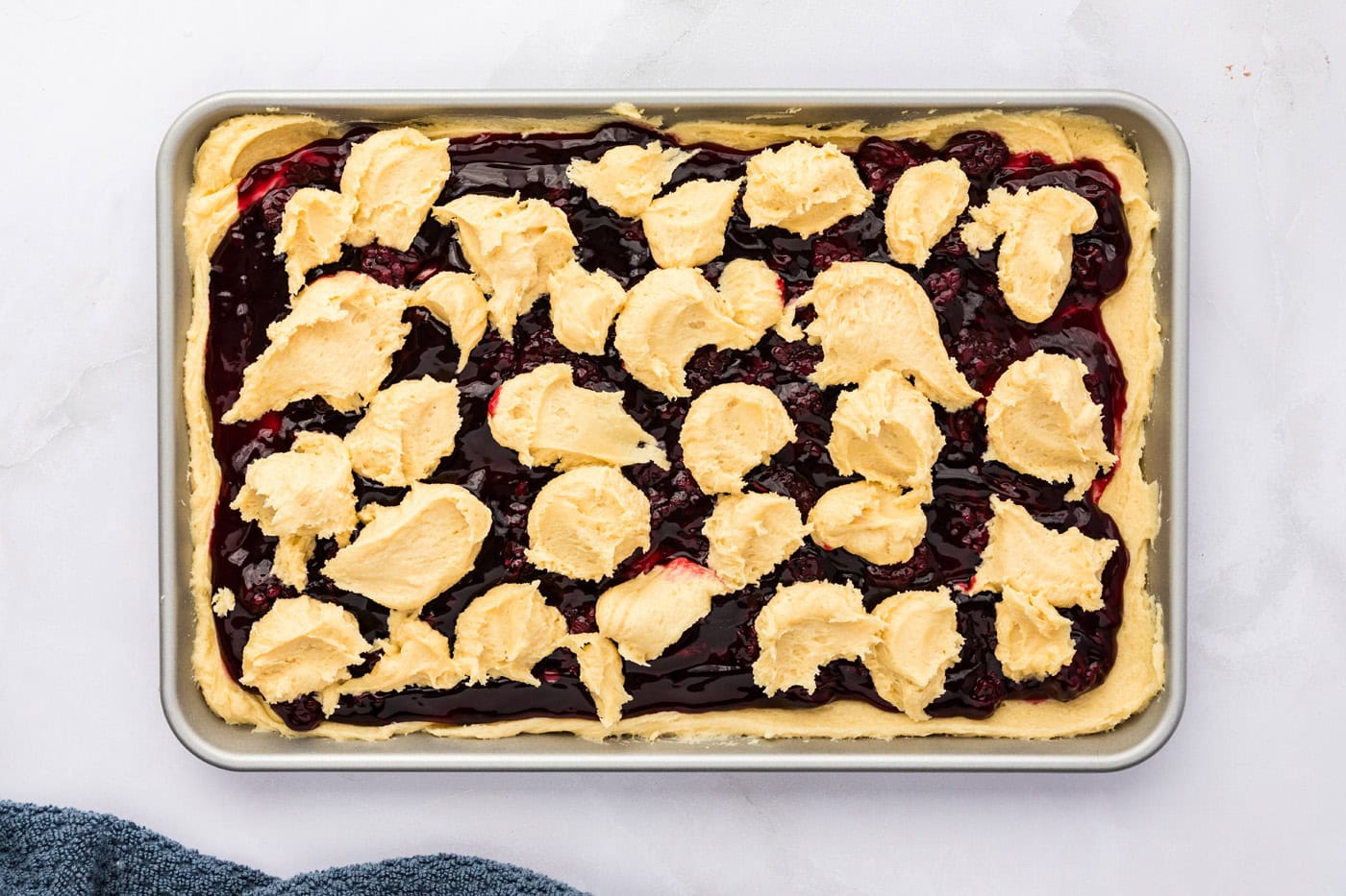 dollops of cookie dough batter on top of blackberry pie filling
