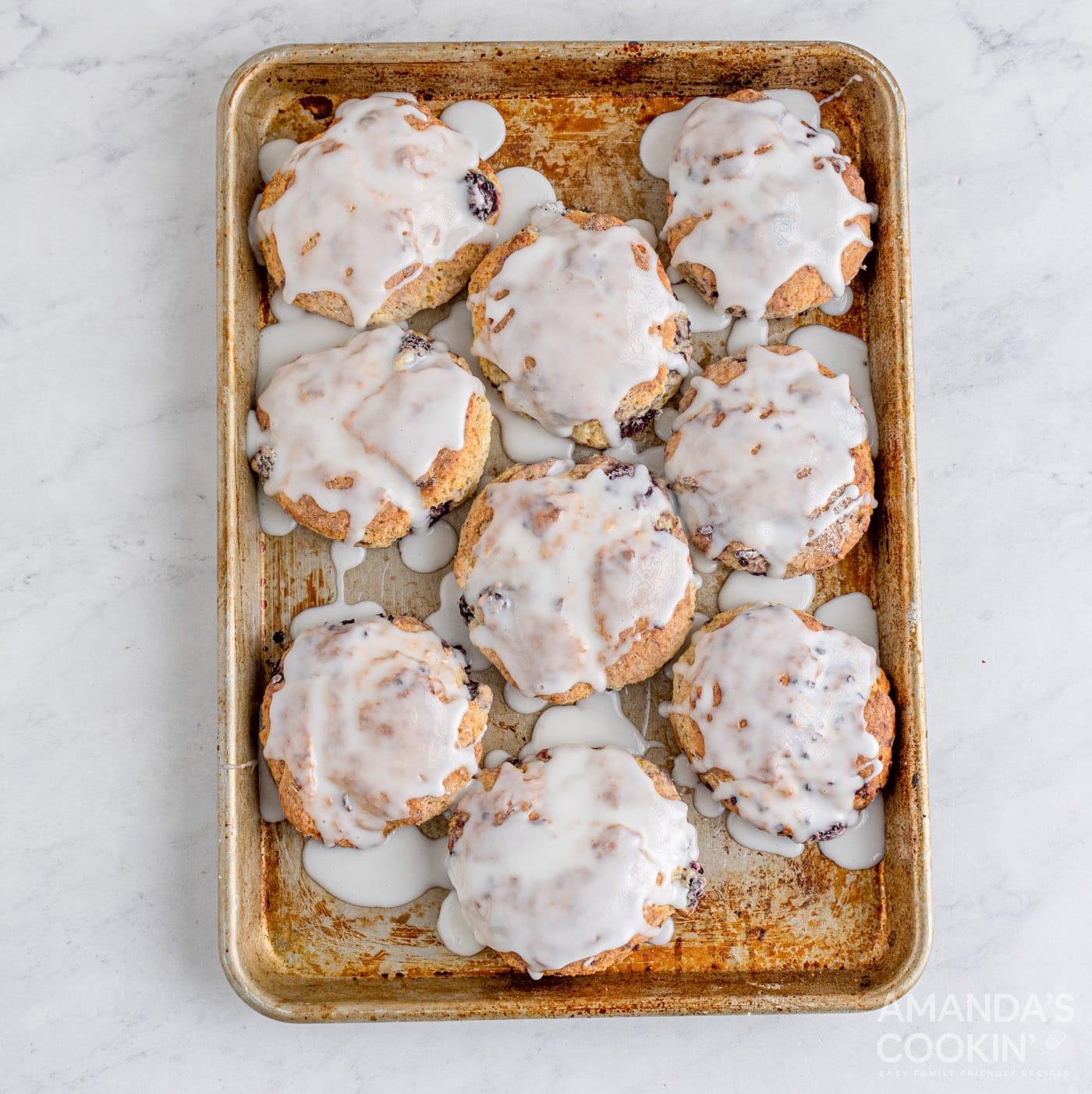 glazed blackberry scones on baking sheet