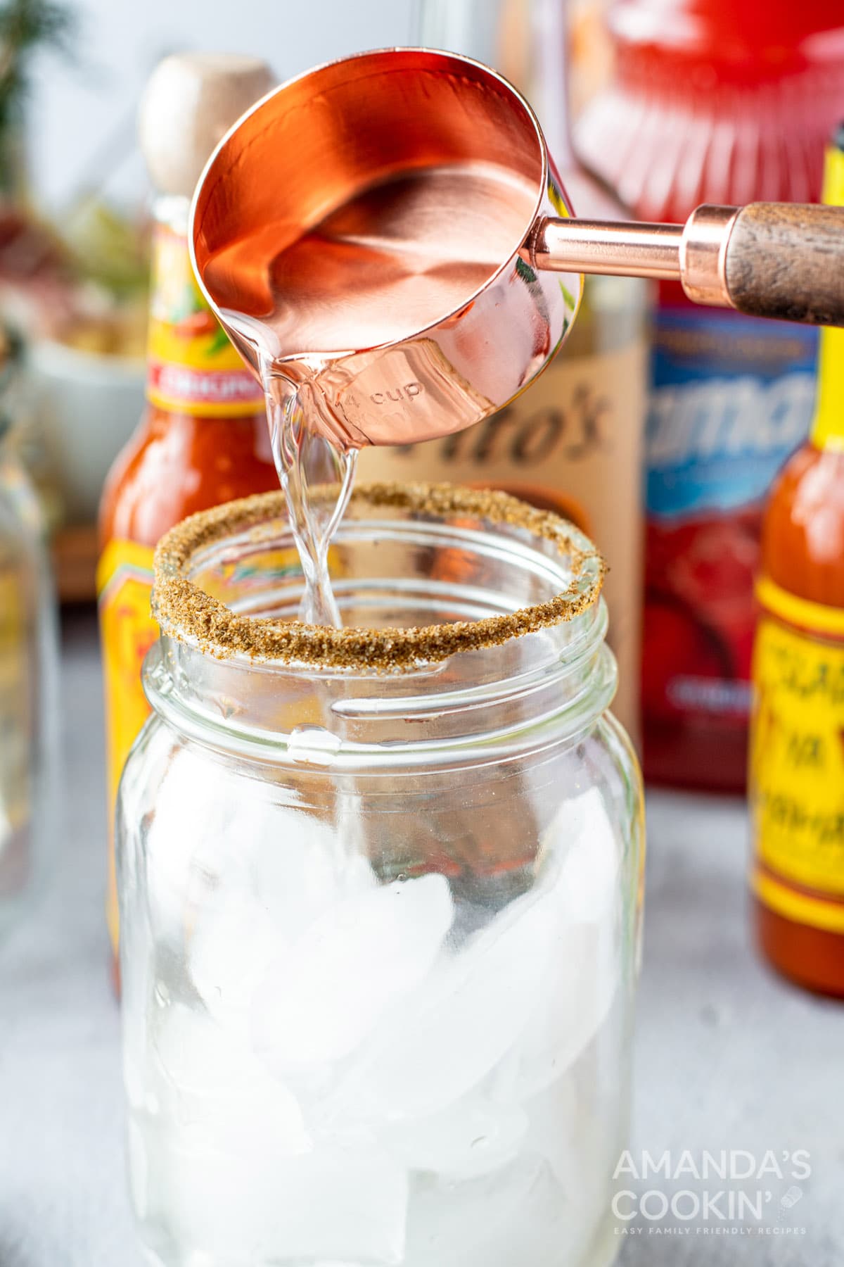 adding vodka to glass