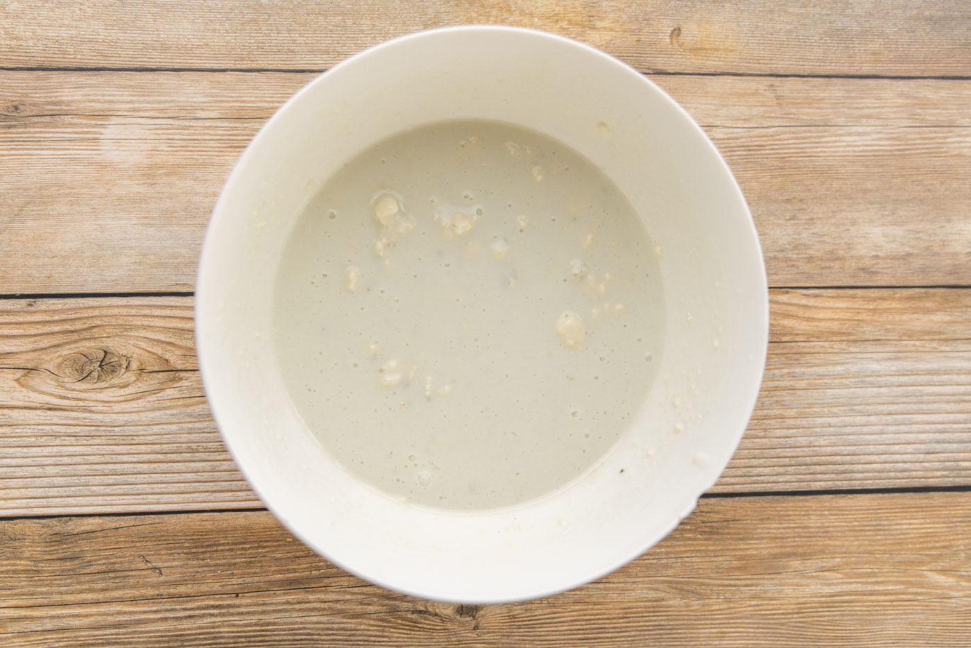 buttermilk and blue cheese crumbles in a mixing bowl
