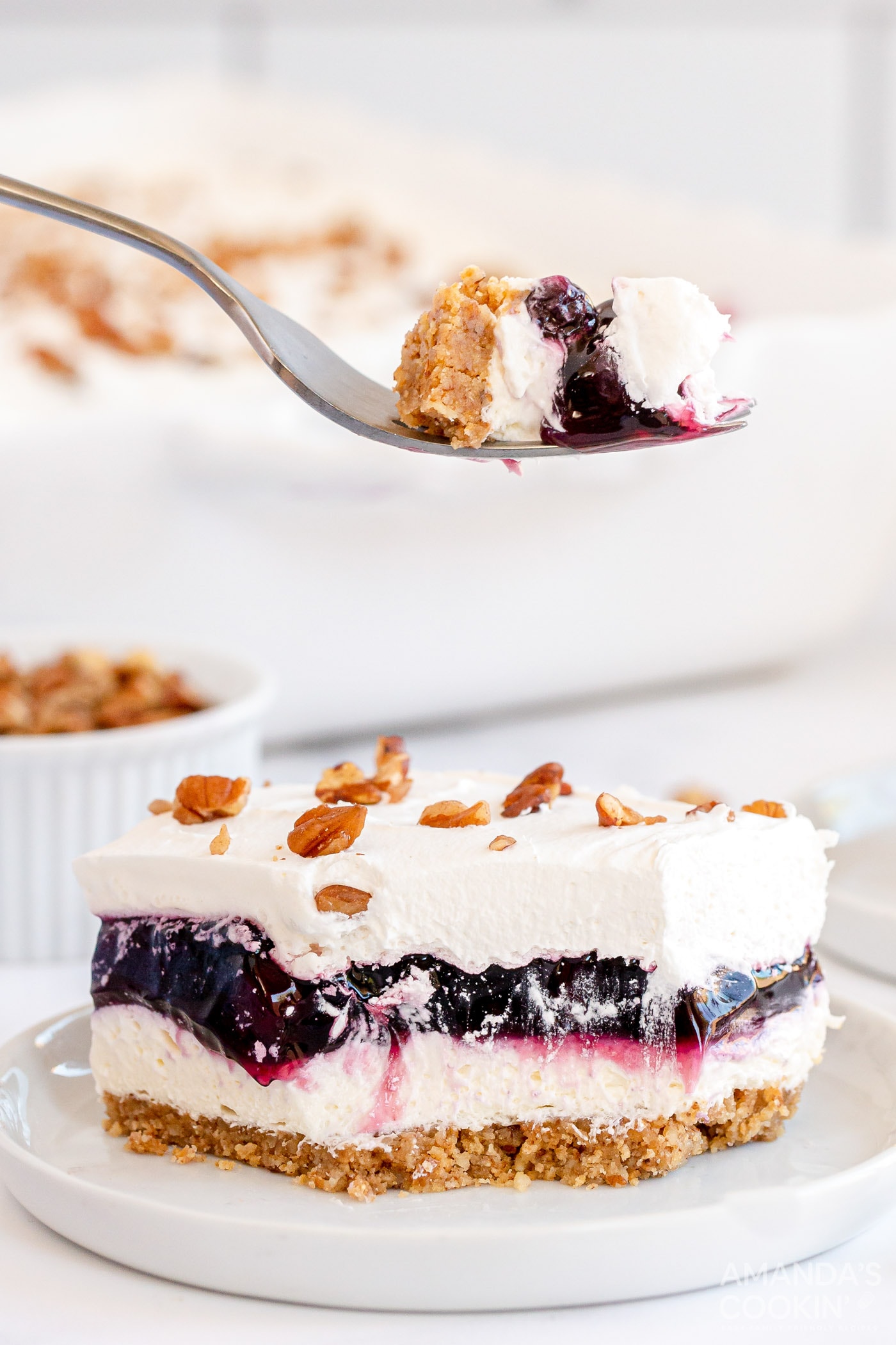 Forkful of Blueberry Delight held above a slice of Blueberry Delight