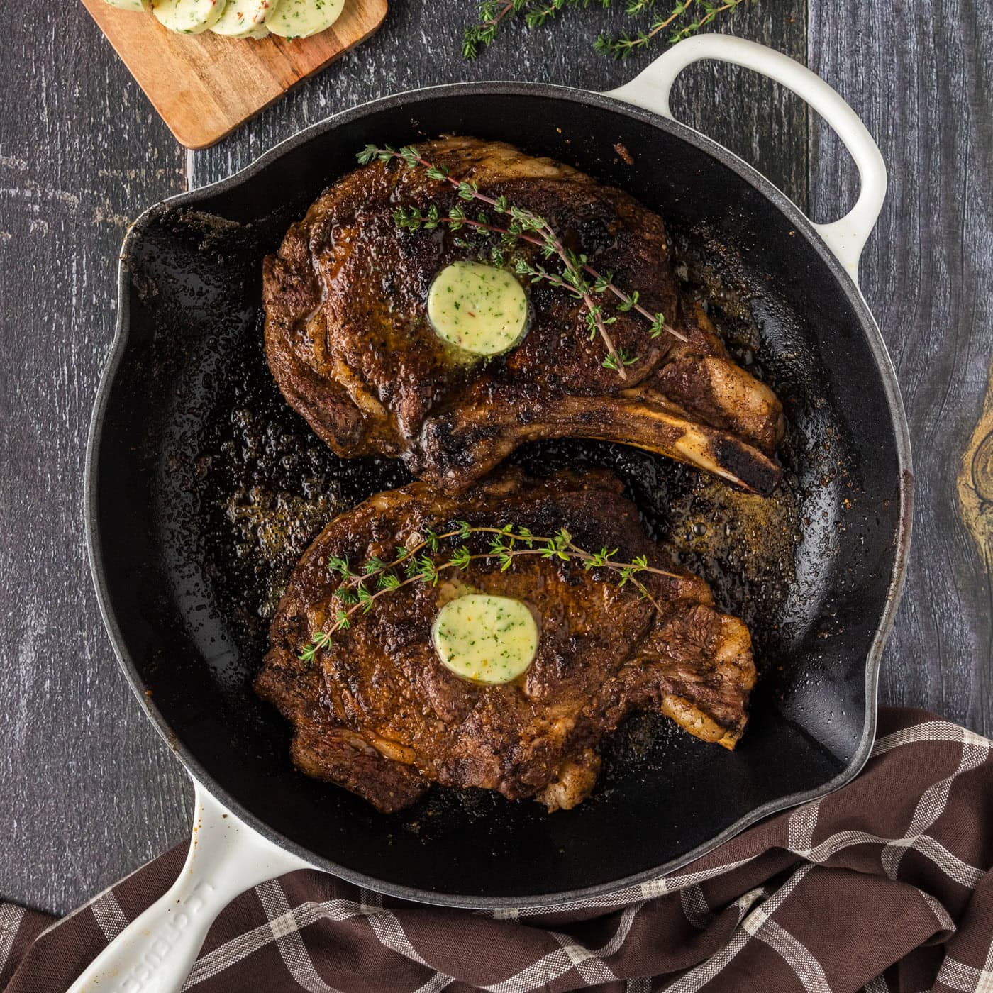Two Bone in Ribeyes in a skillet