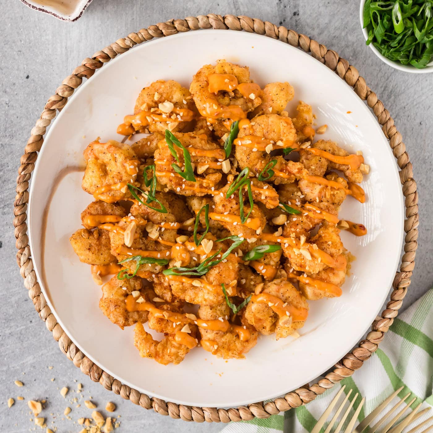 Plate of Boom Boom Shrimp topped with green onion and sesame seeds