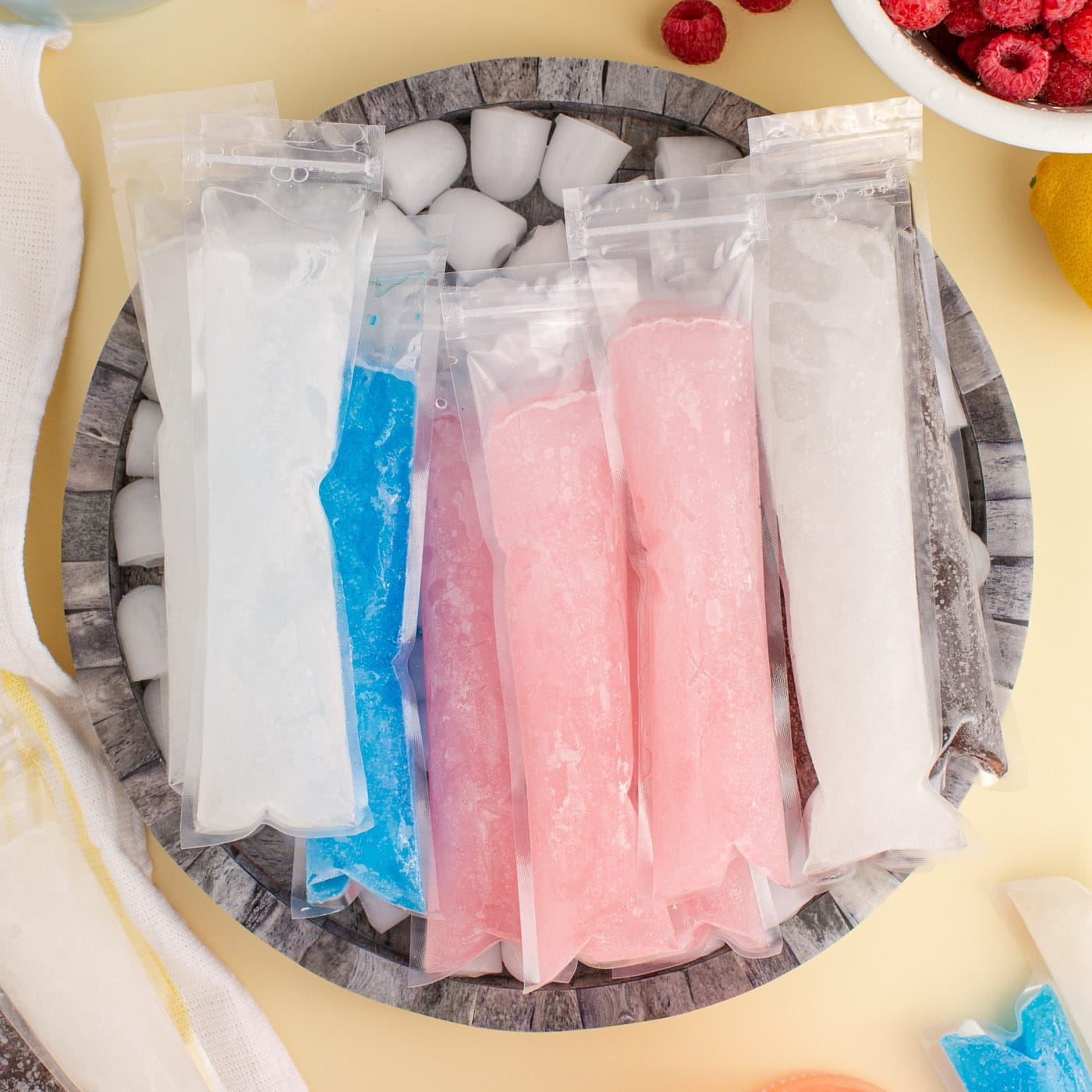 Close up photo of assorted Boozy Ice Pops in a bowl of ice