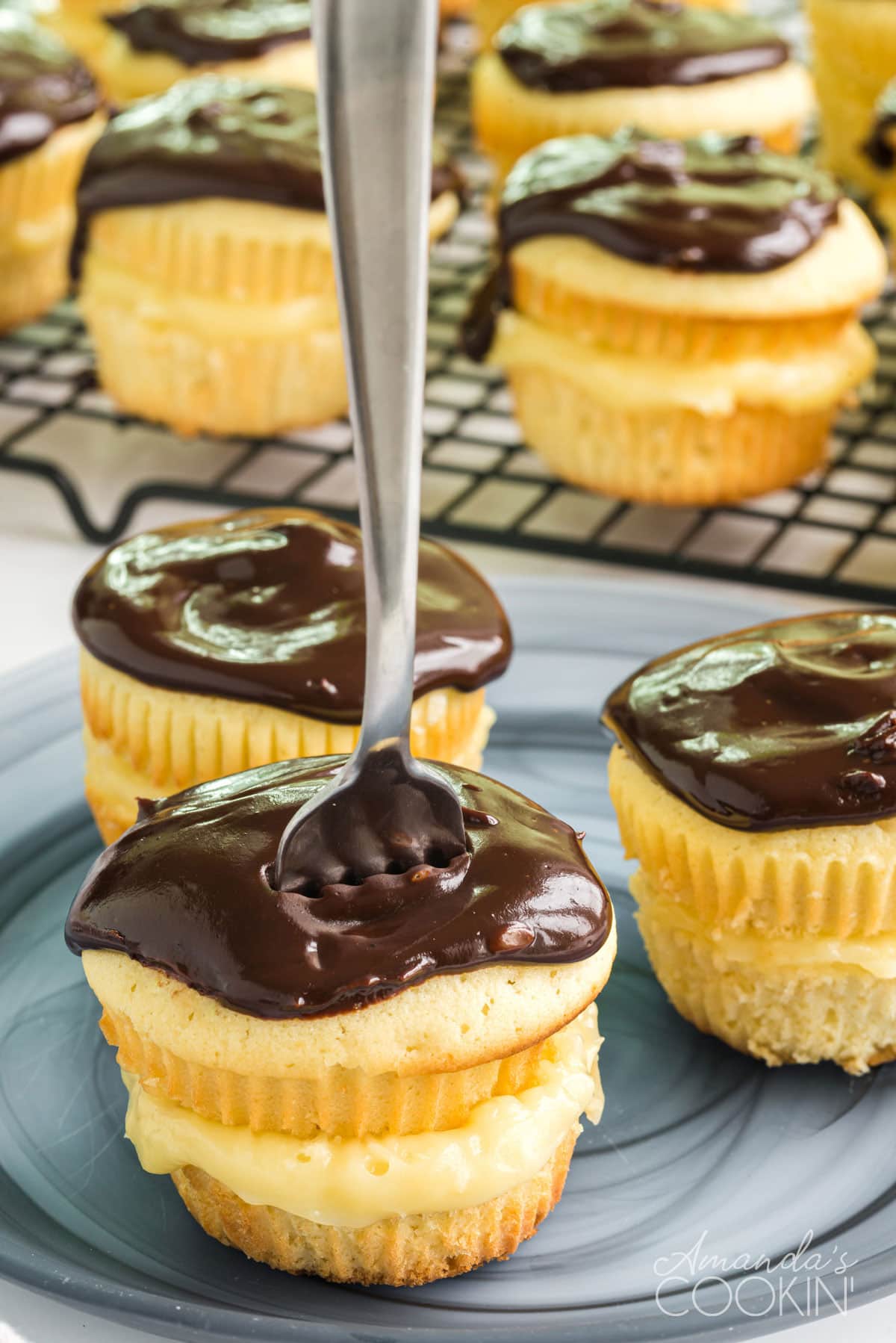 boston cream cupcake with a fork standing in the top of it