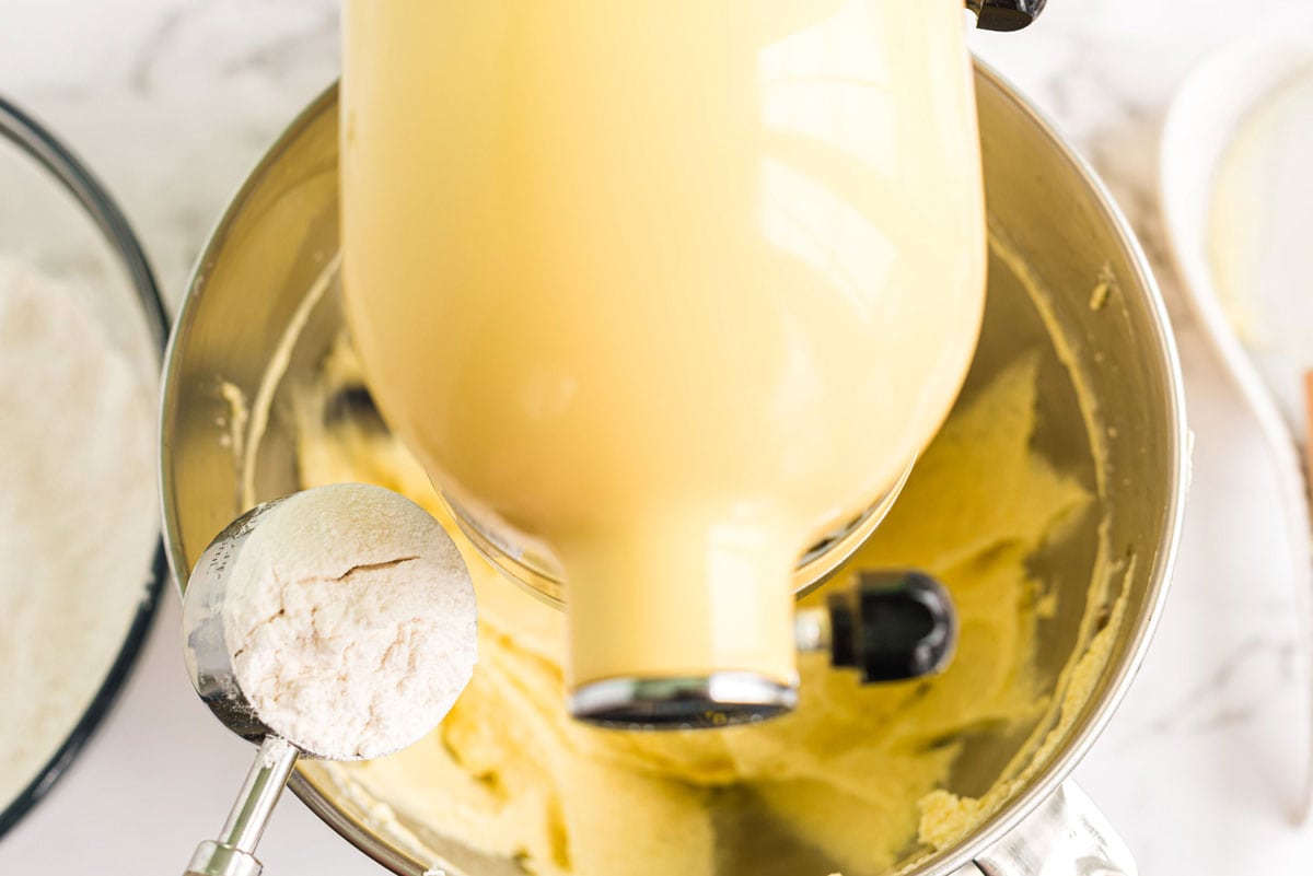 adding flour to mixer