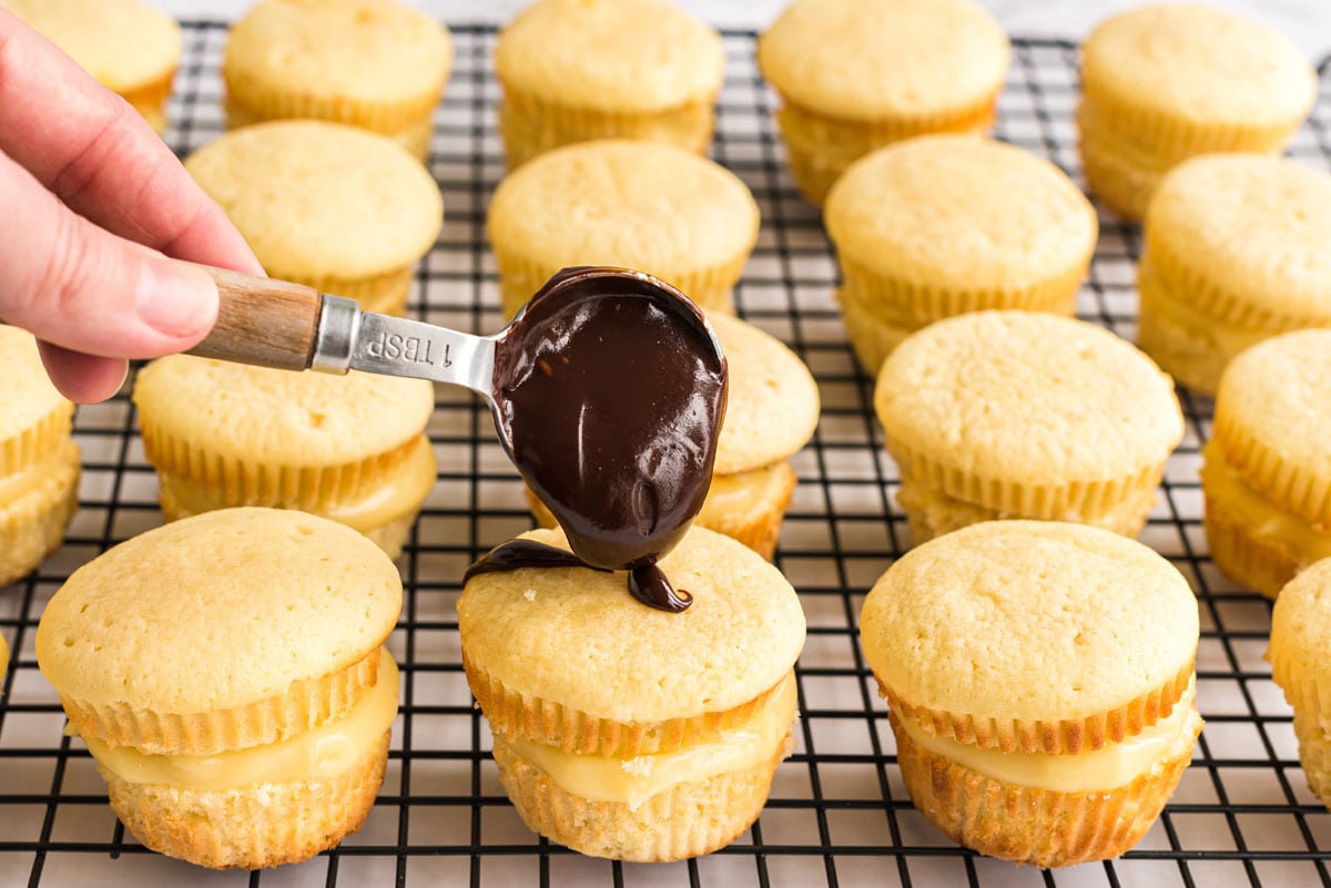 adding ganache to top of cupcake