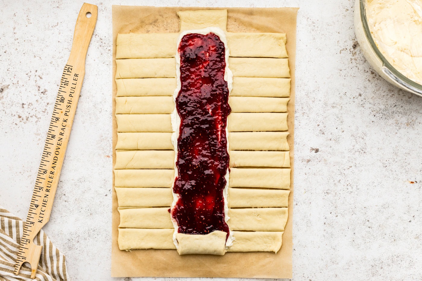 strips cut out on sides of dough along the filling lines
