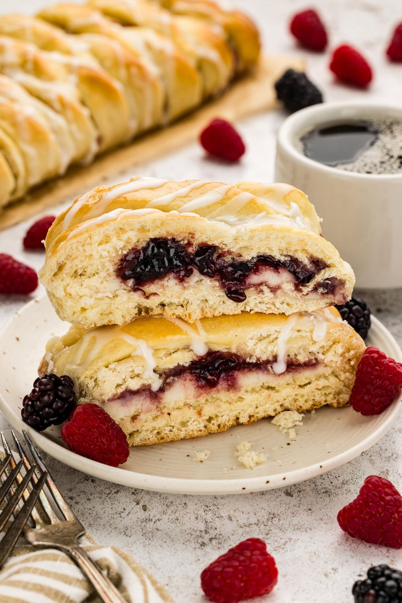 Two slices of Braided Breakfast Danish stacked on a plate