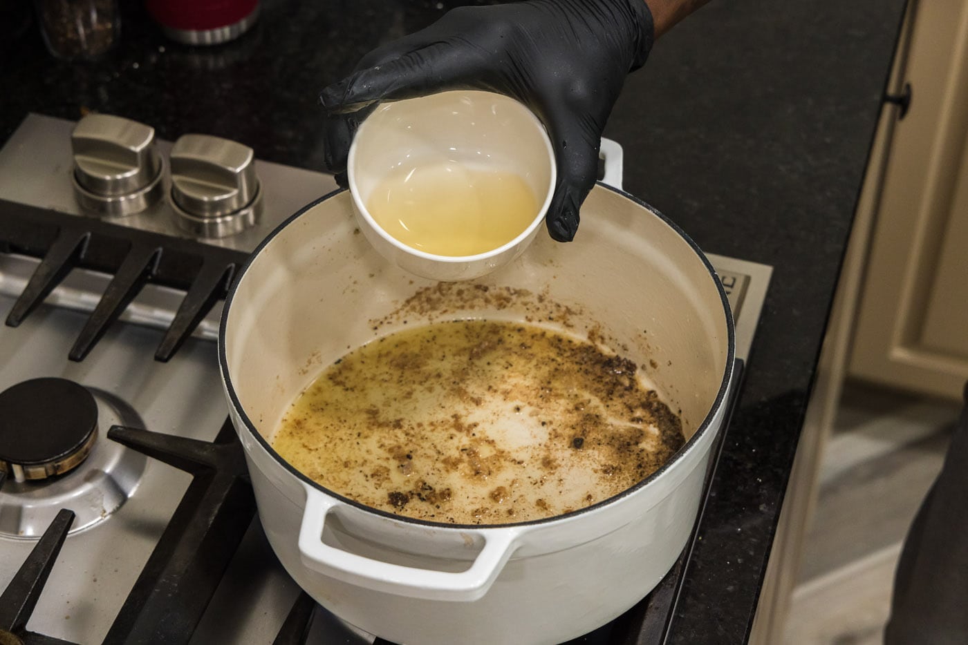 adding white wine to deglaze pan