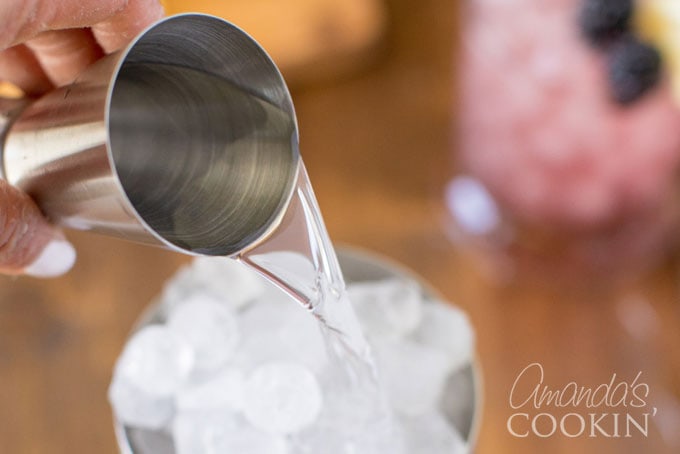 adding gin to cocktail shaker