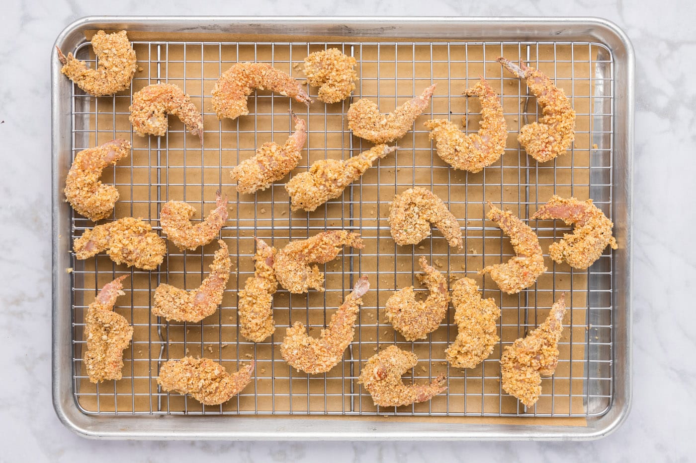 breaded shrimp on a baking sheet