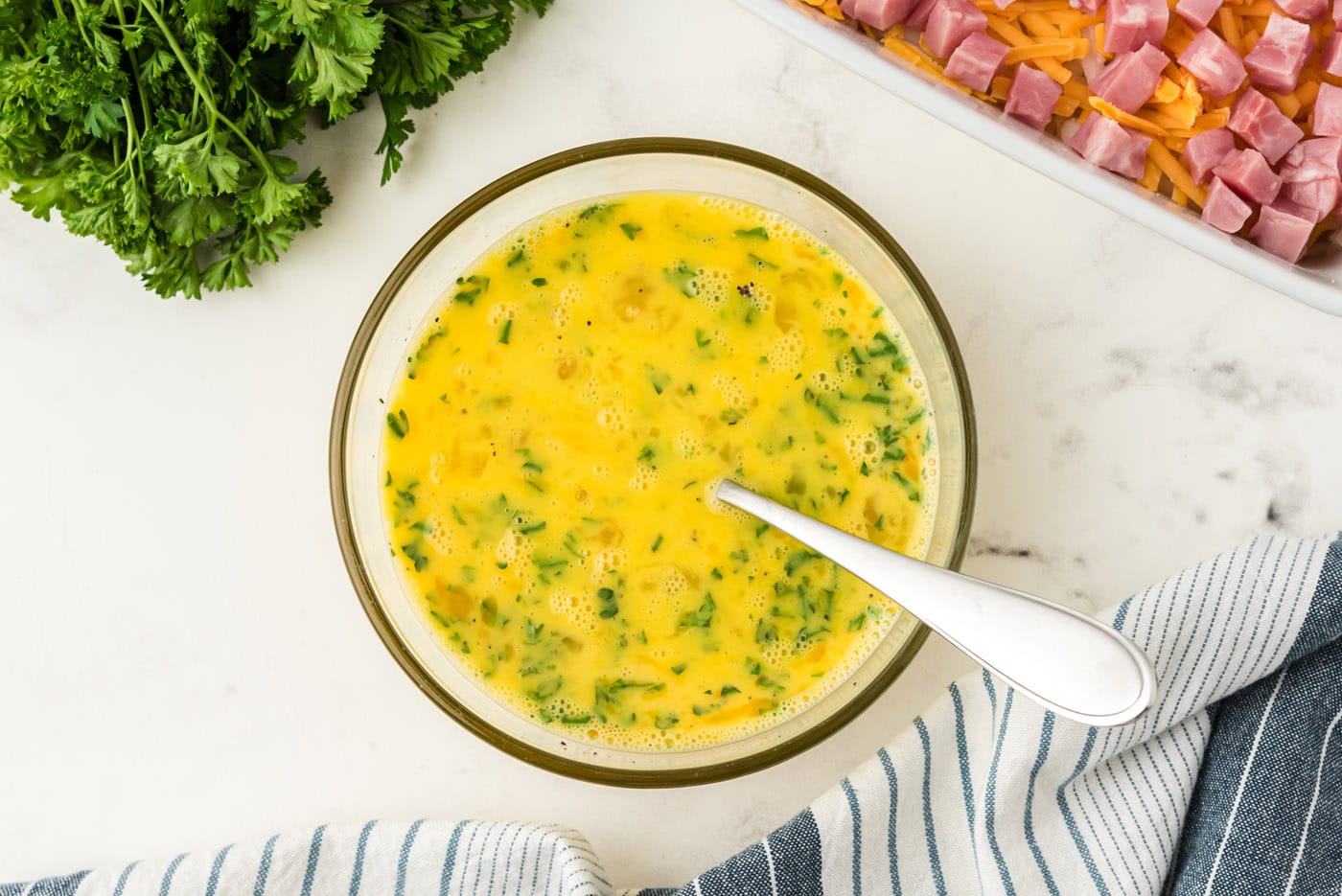 egg and parsley mixed in a bowl