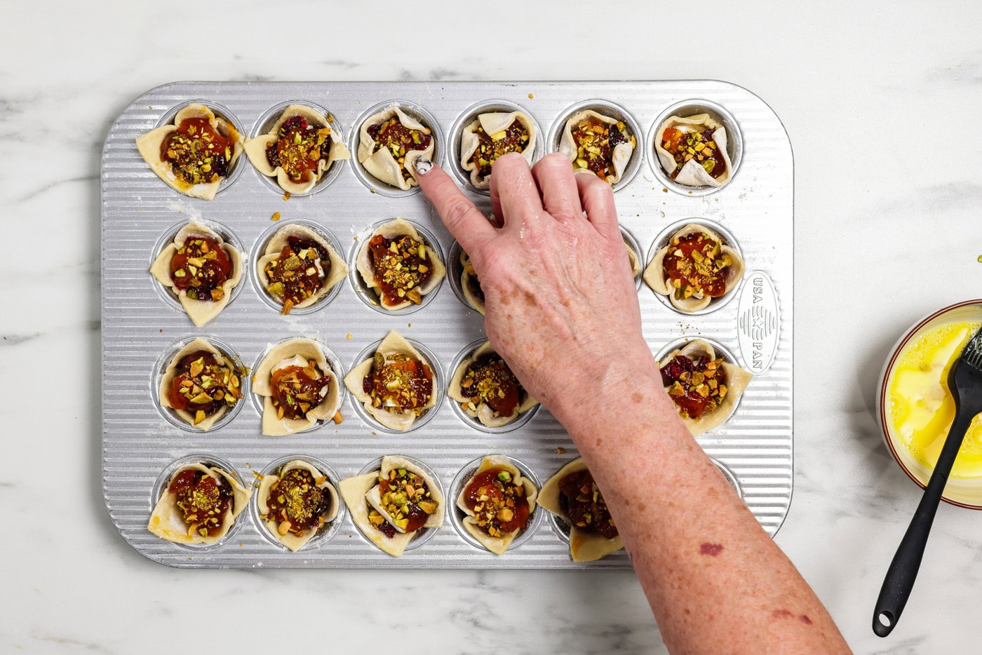 finger gently pressing sides of puff pastry inwards