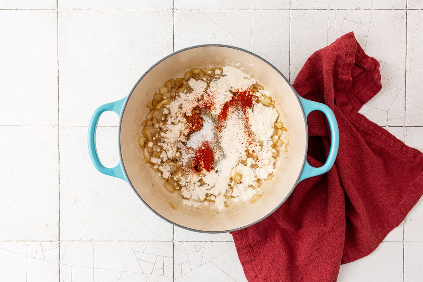 seasonings, flour, onion, and garlic in a dutch oven