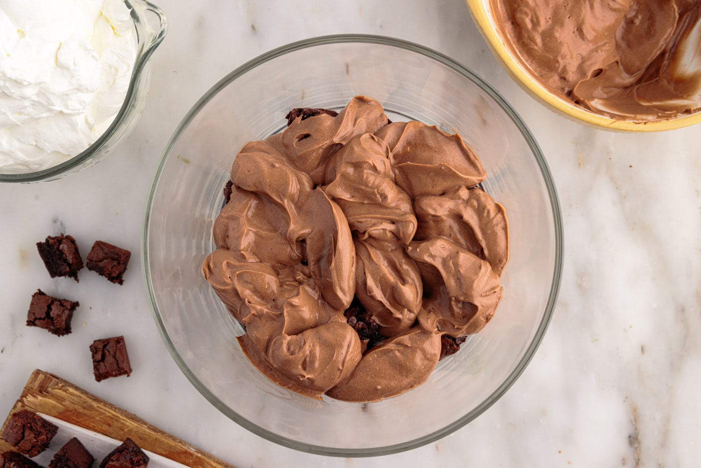 whipped chocolate pudding over brownie chunks in a trifle dish
