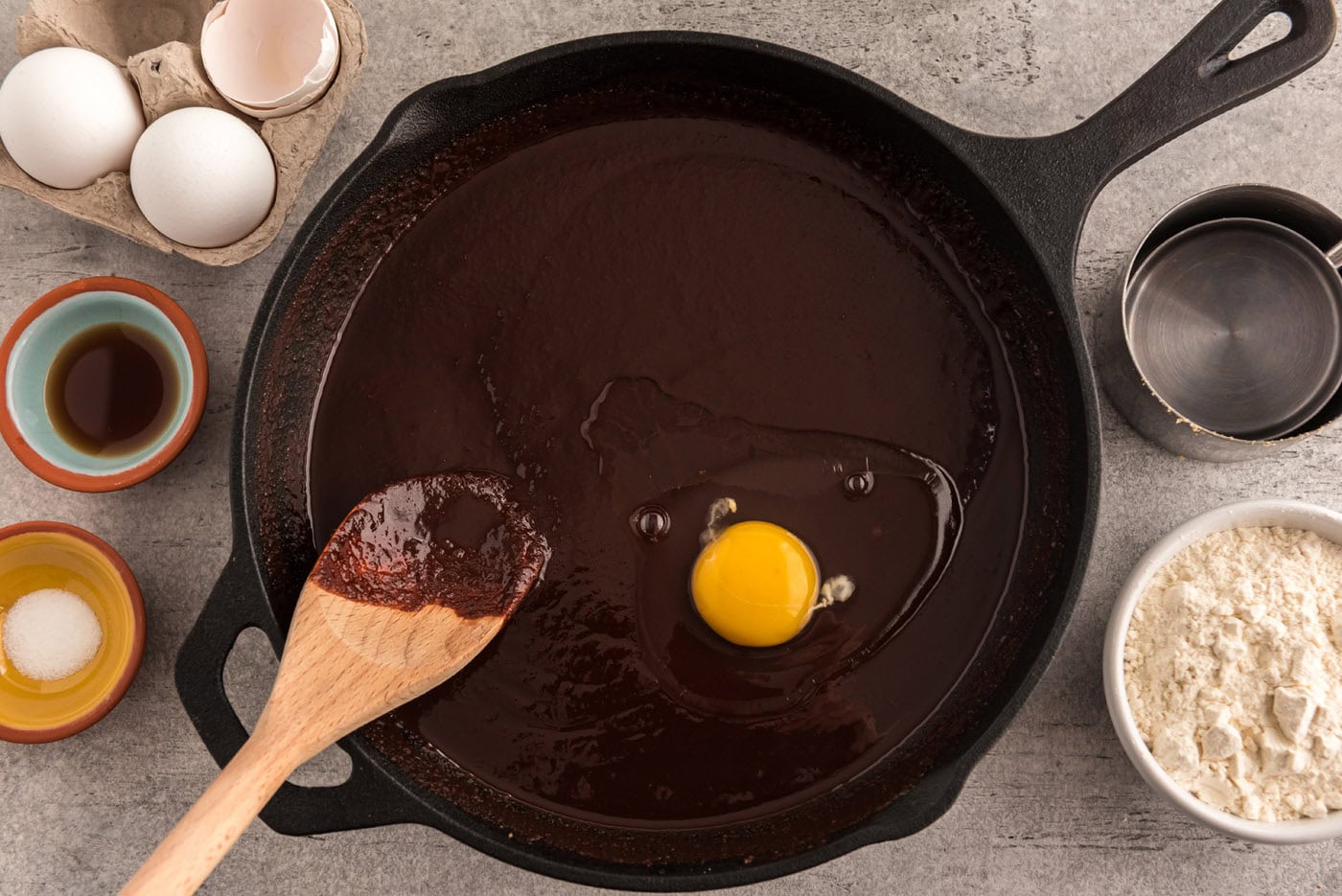 mixing egg into chocolate mixture in a skillet