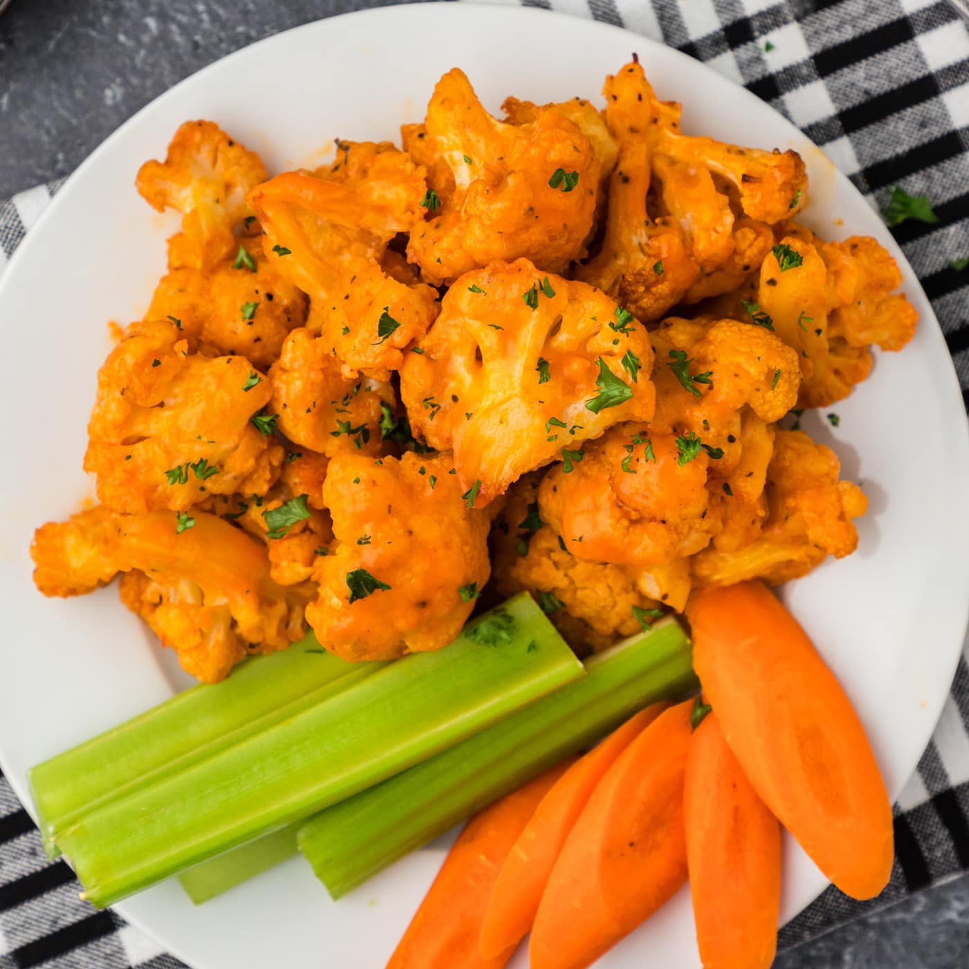 Buffalo Cauliflower on a plate with celery and carrots