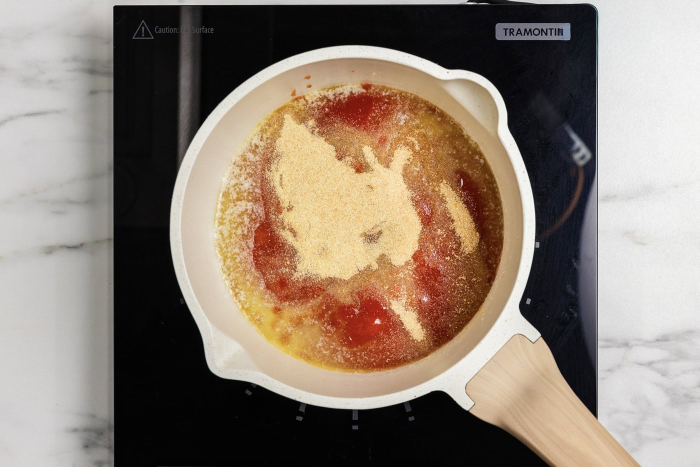 Hot sauce, garlic and onion powder, and butter in a saucepan