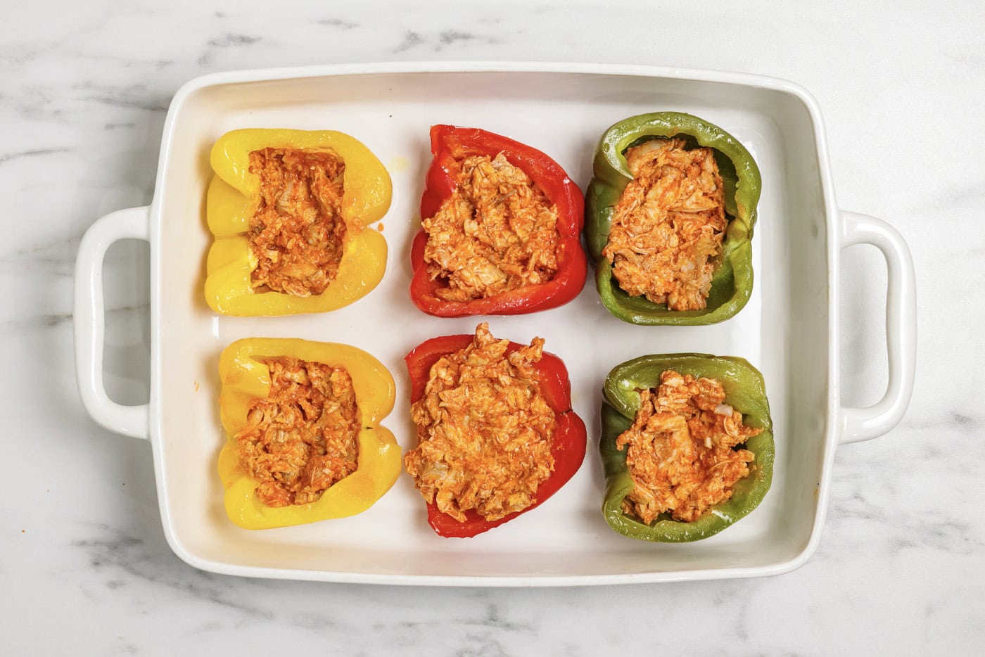 Buffalo chicken mixture stuffed inside bell pepper halves