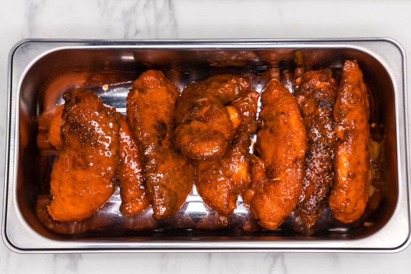 buffalo chicken tenders on a pan