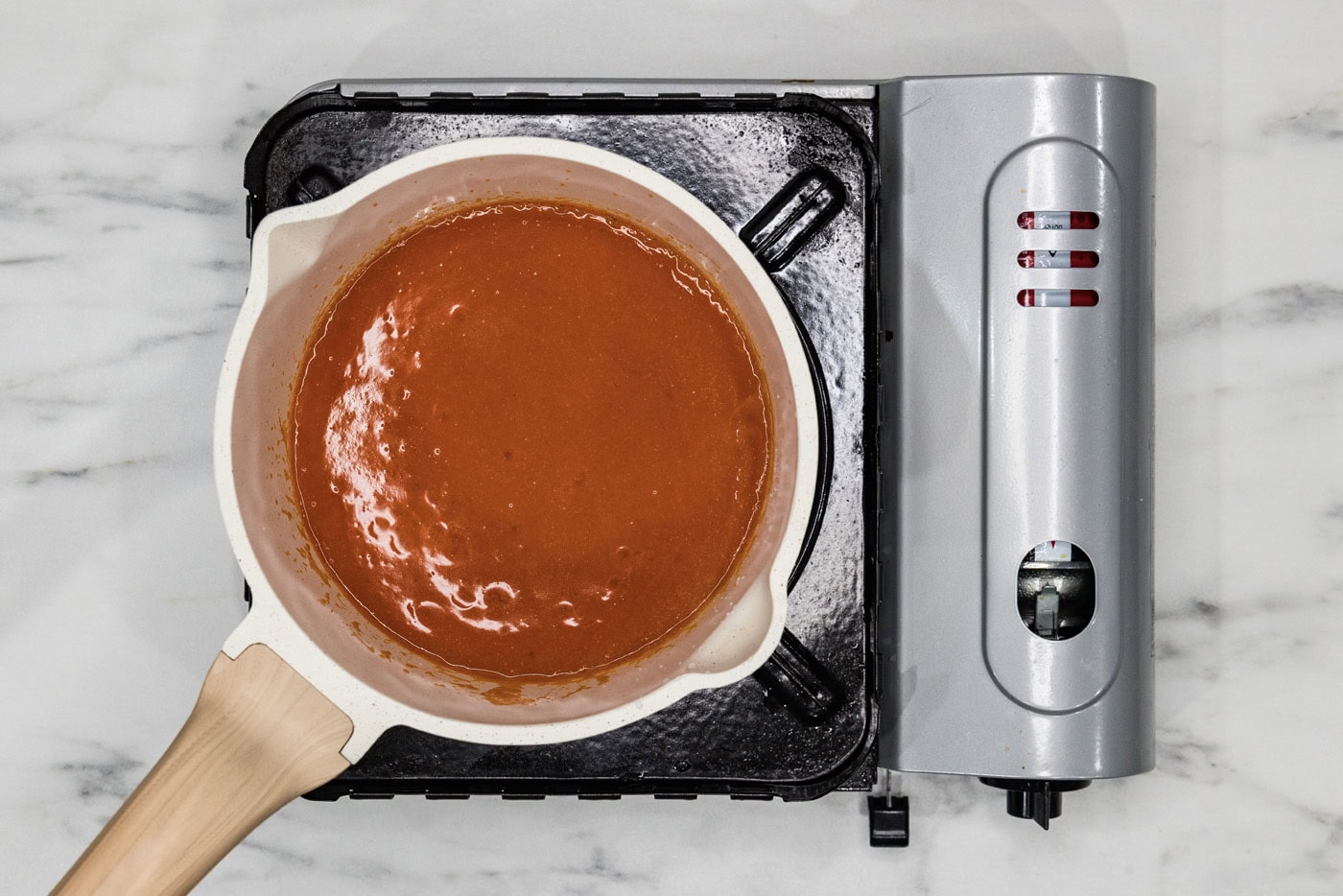 homemade buffalo sauce in a medium saucepan