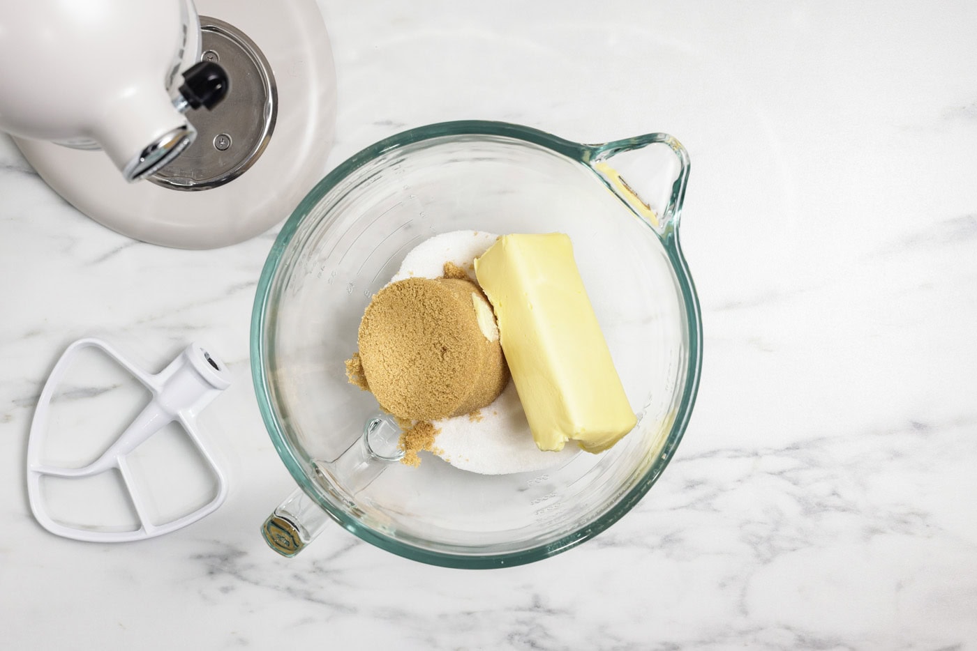 Shortening with granulated and brown sugar in a stand mixer bowl
