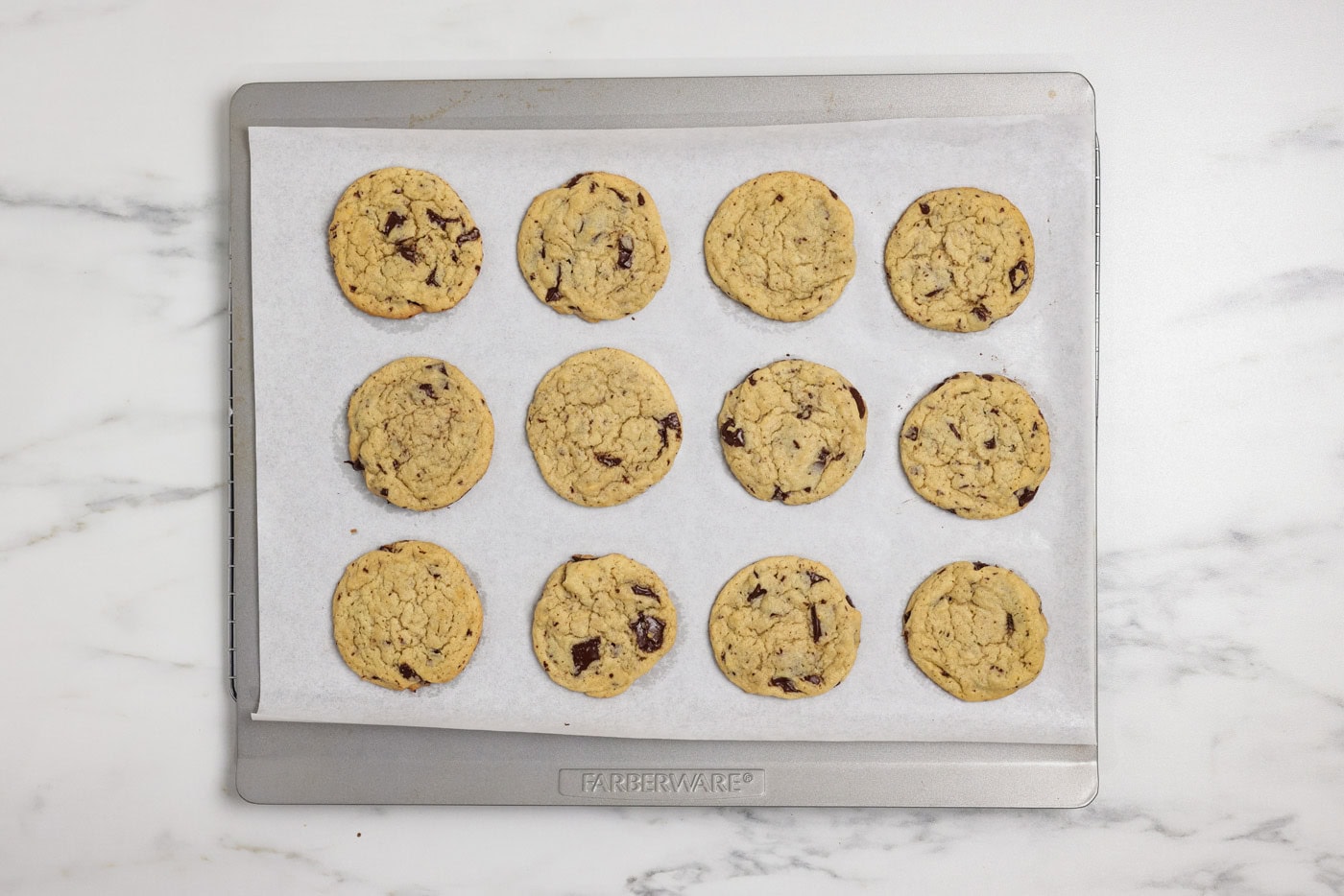 Baked buttermilk chocolate chip cookies on an insulated baking sheet