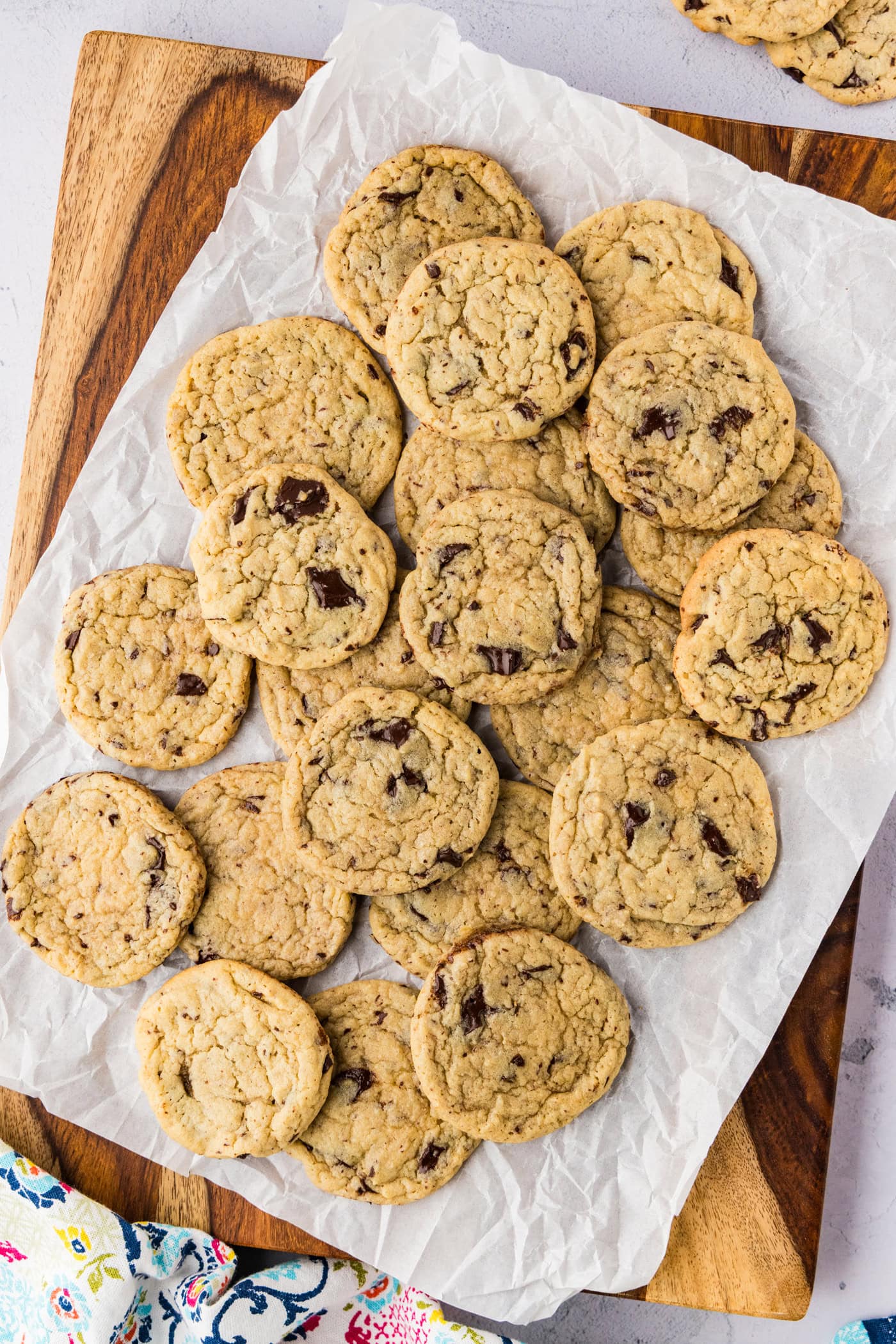 Buttermilk Chocolate Chip Cookies piled on parchment paper