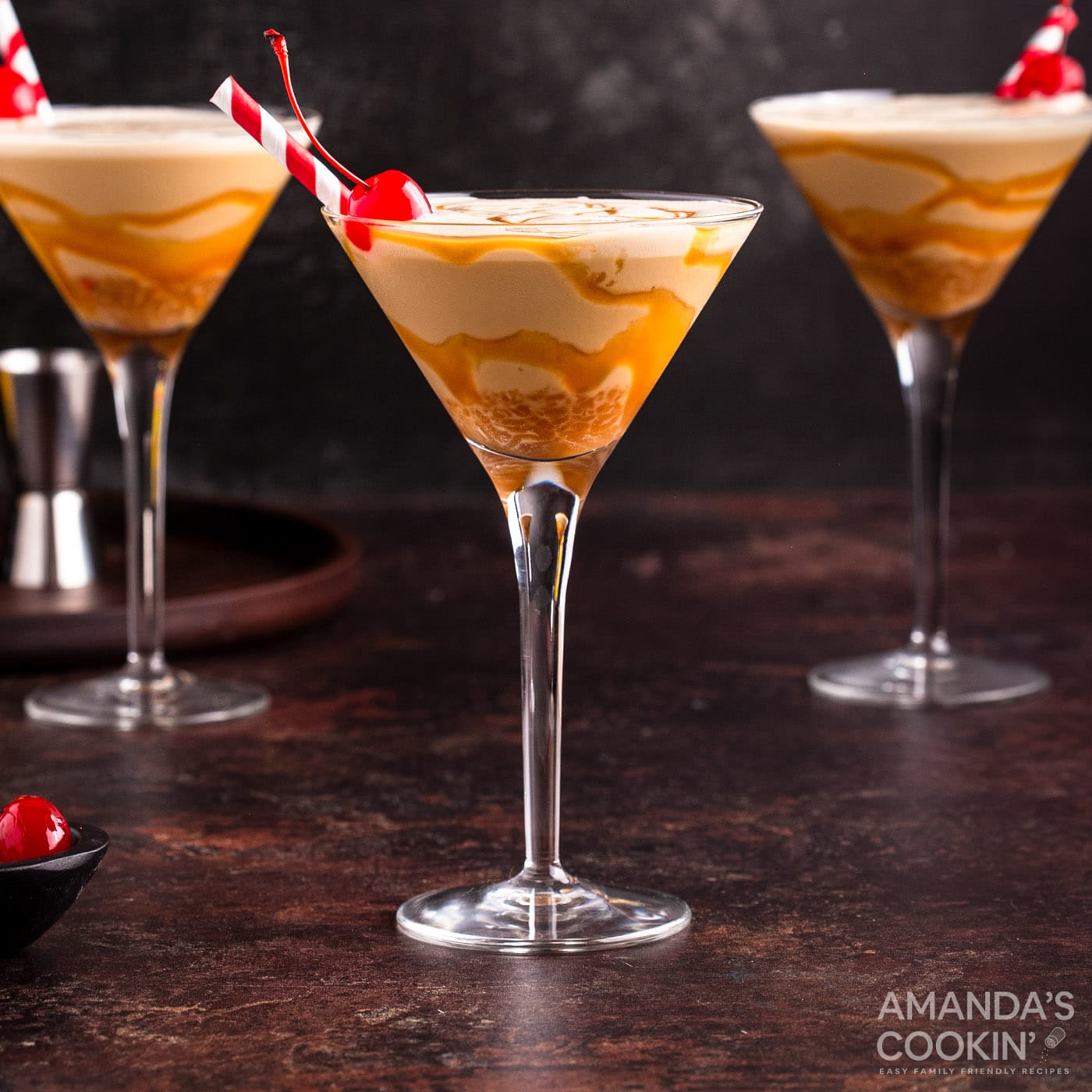 butterscotch milkshake cocktail in a martini glass with a cherry garnish