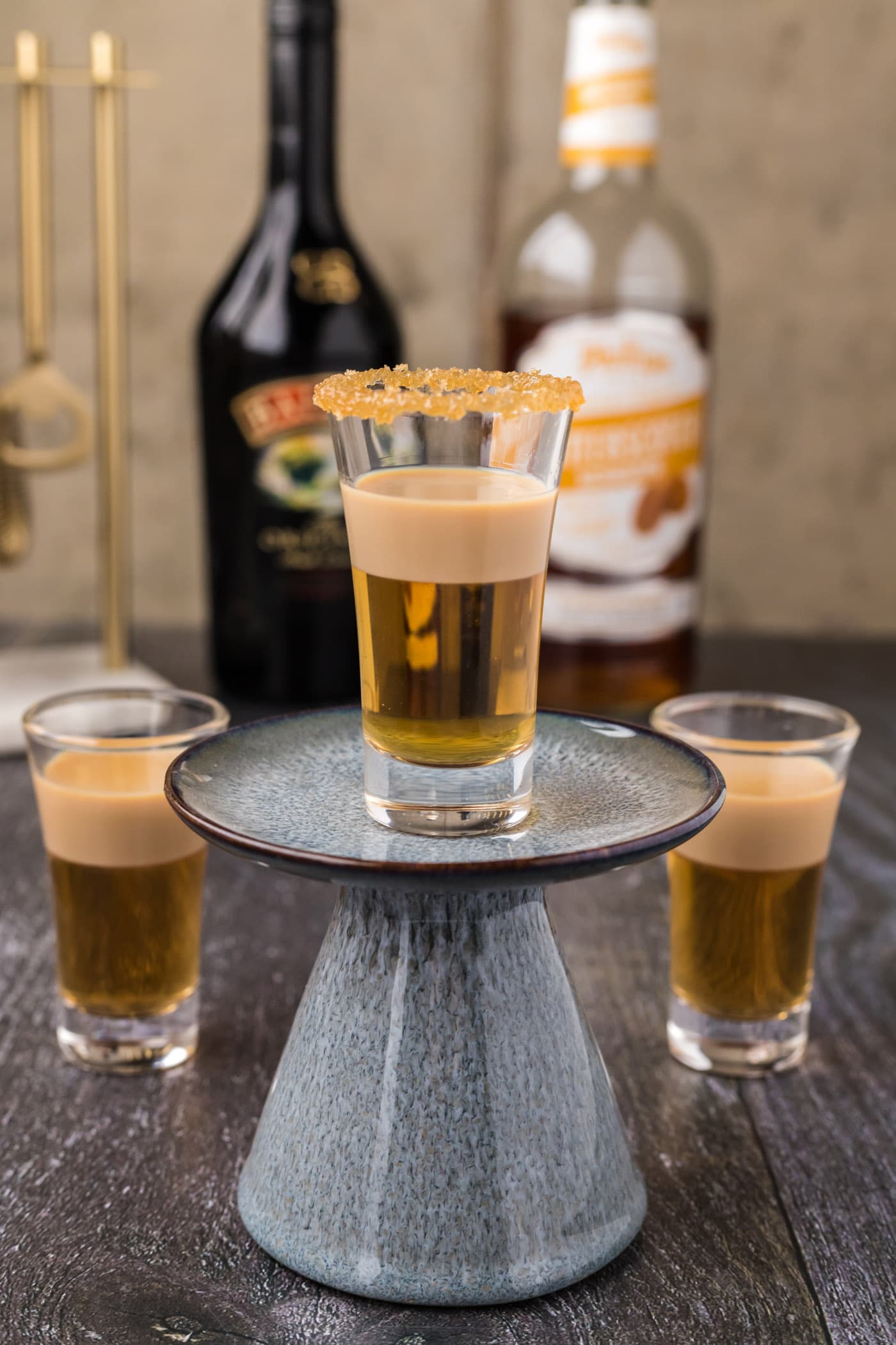 Buttery Nipple Shot resting on a cupcake stand