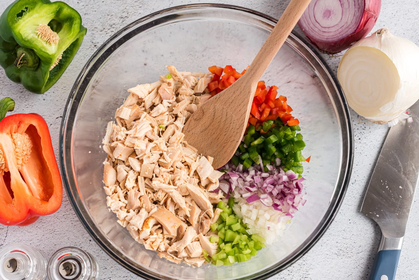 chicken, celery, green and red bell pepper,,and onion in a mixing bowl