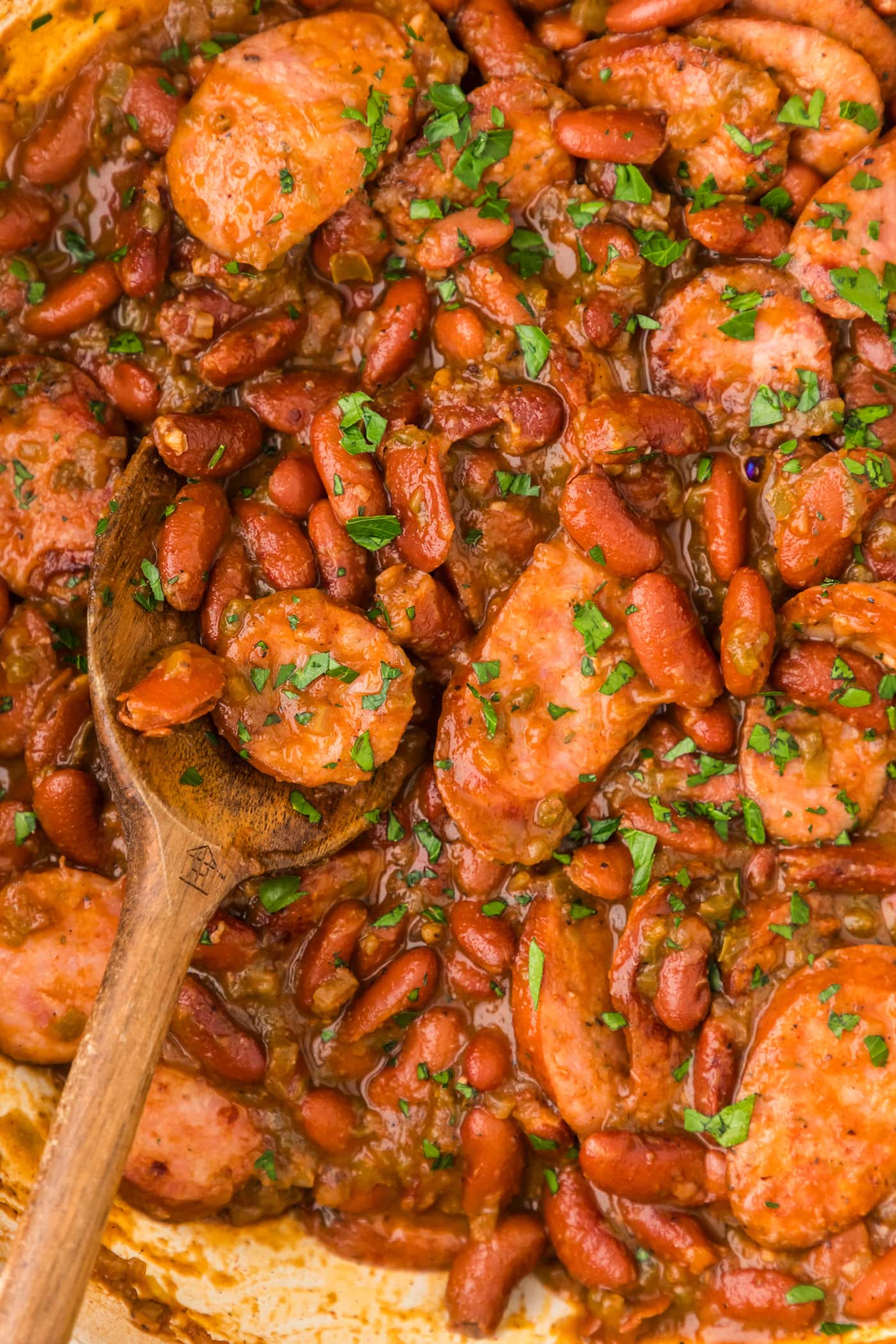 Close up photo of Cajun Red Beans in a skillet with a spoon