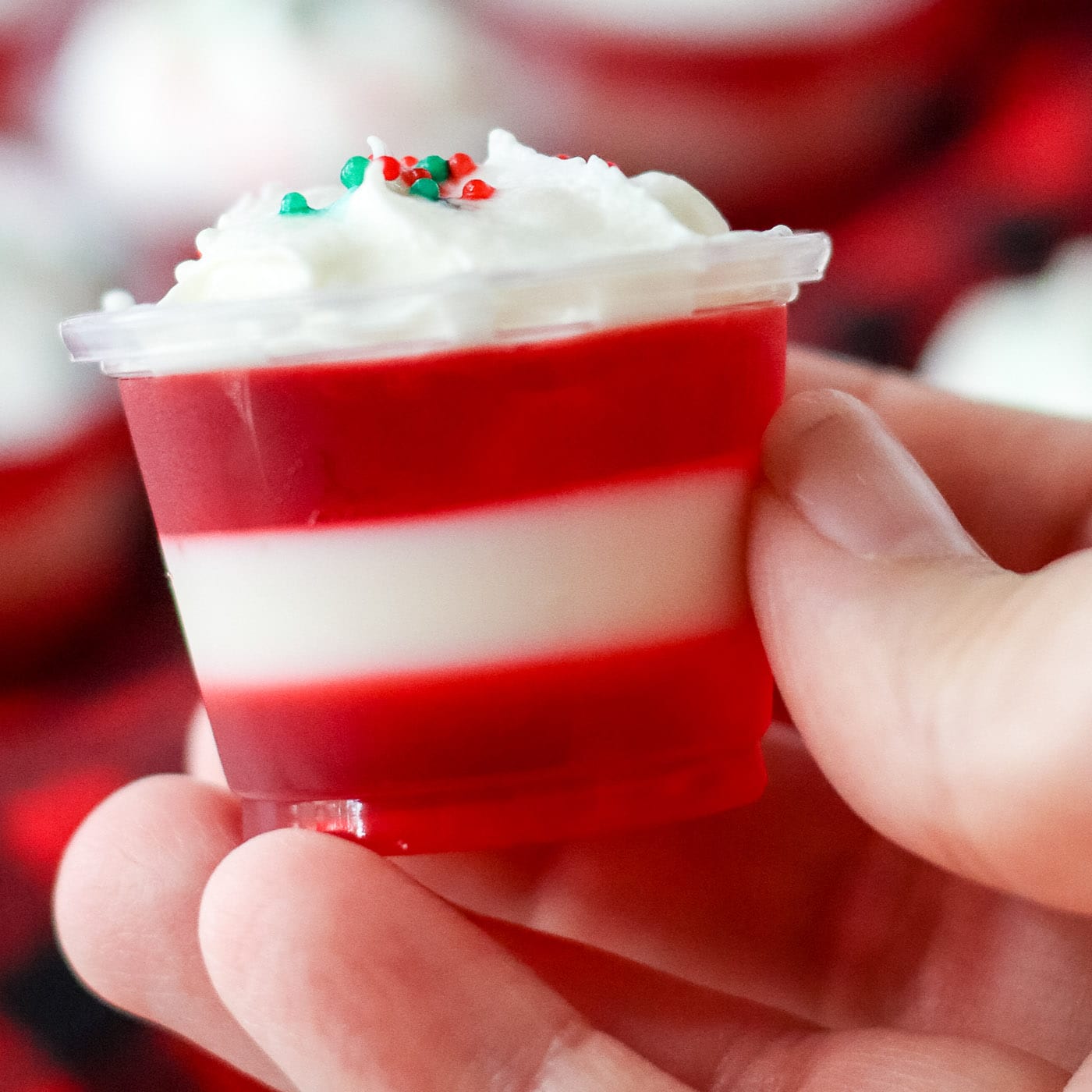 hand holding Candy Cane Jello Shot
