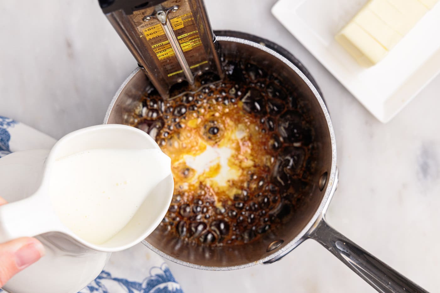 heavy cream pouring into caramel sauce