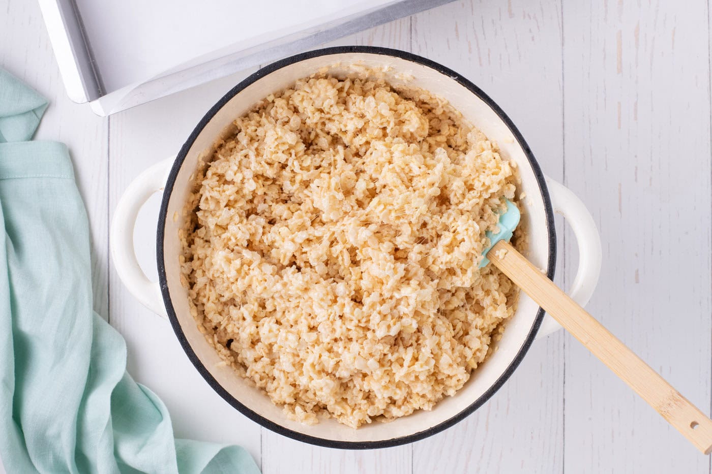 mixing melted marshmallows with rice krispie cereal