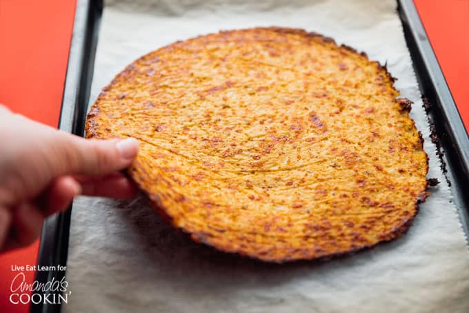 Cauliflower Pizza Crust being lifted up