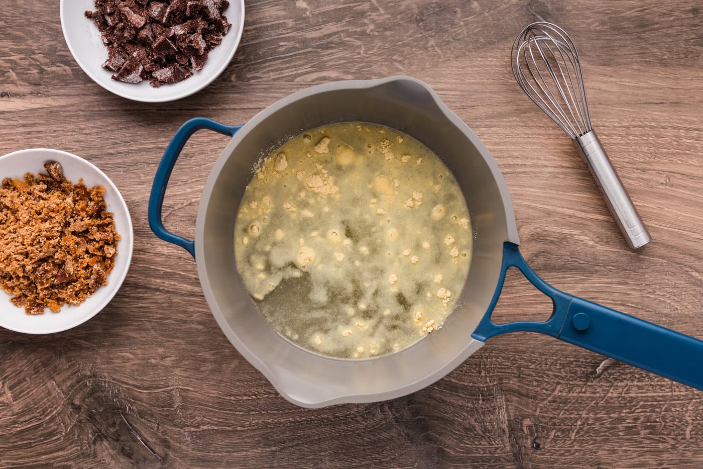 Masa harina added to warm water in a large saucepan