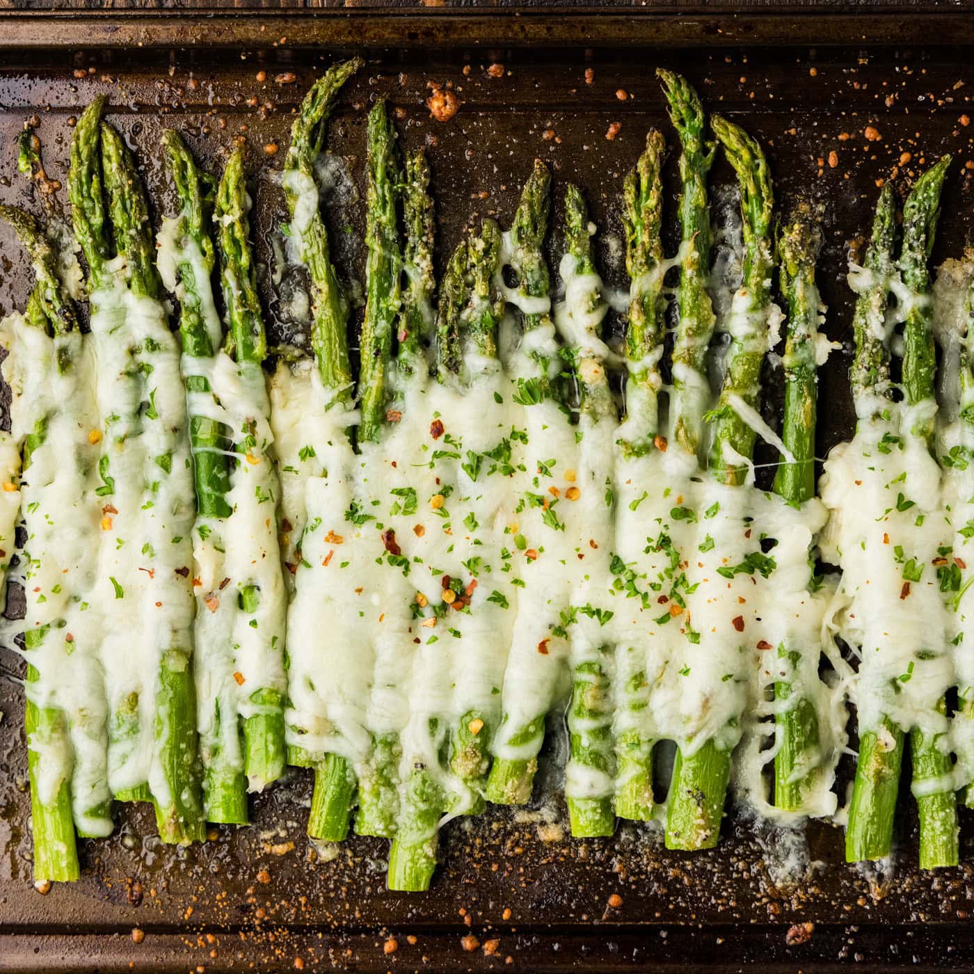 pan of asparagus with cheese melted on top