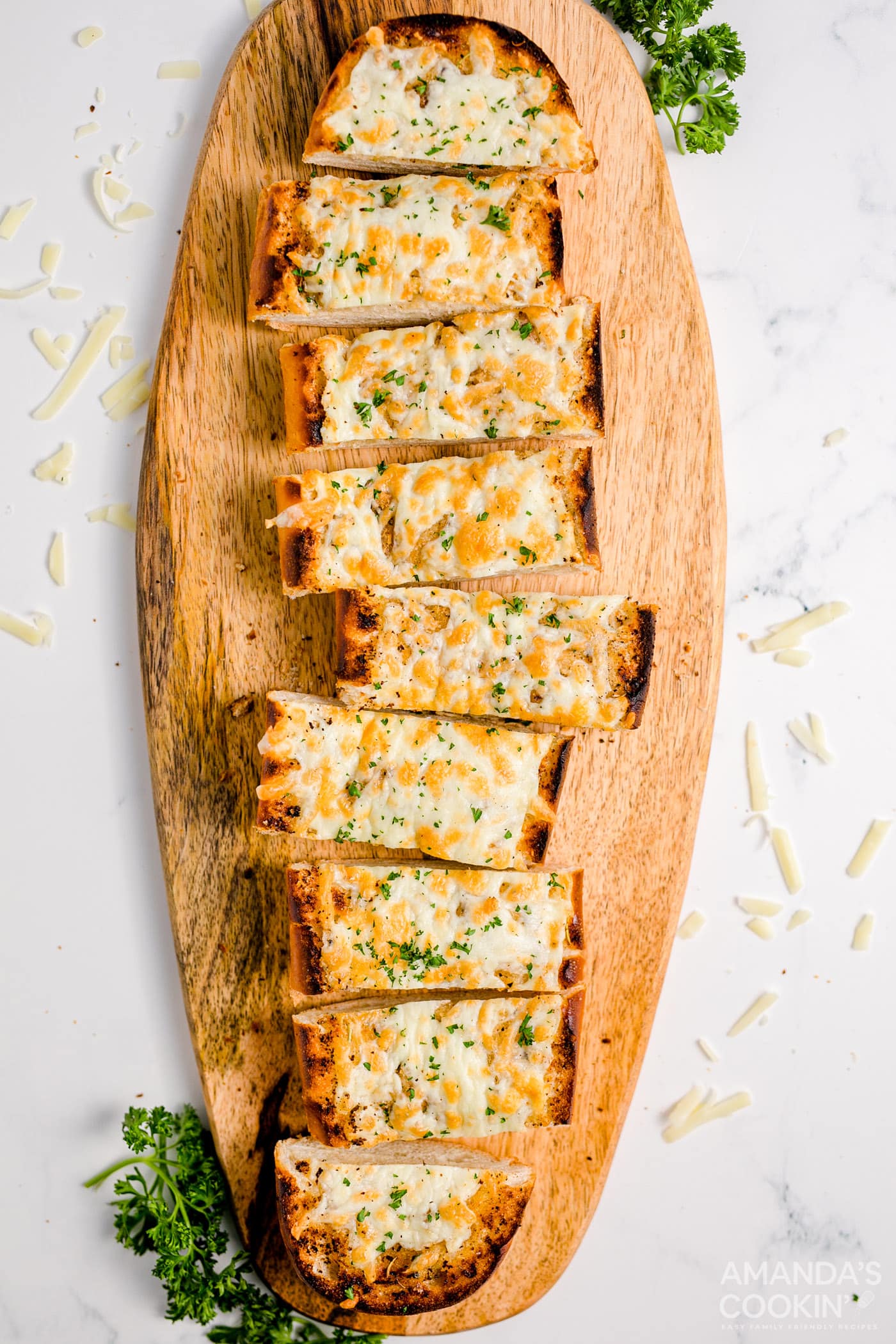 sliced Cheesy Garlic Bread on a cutting board