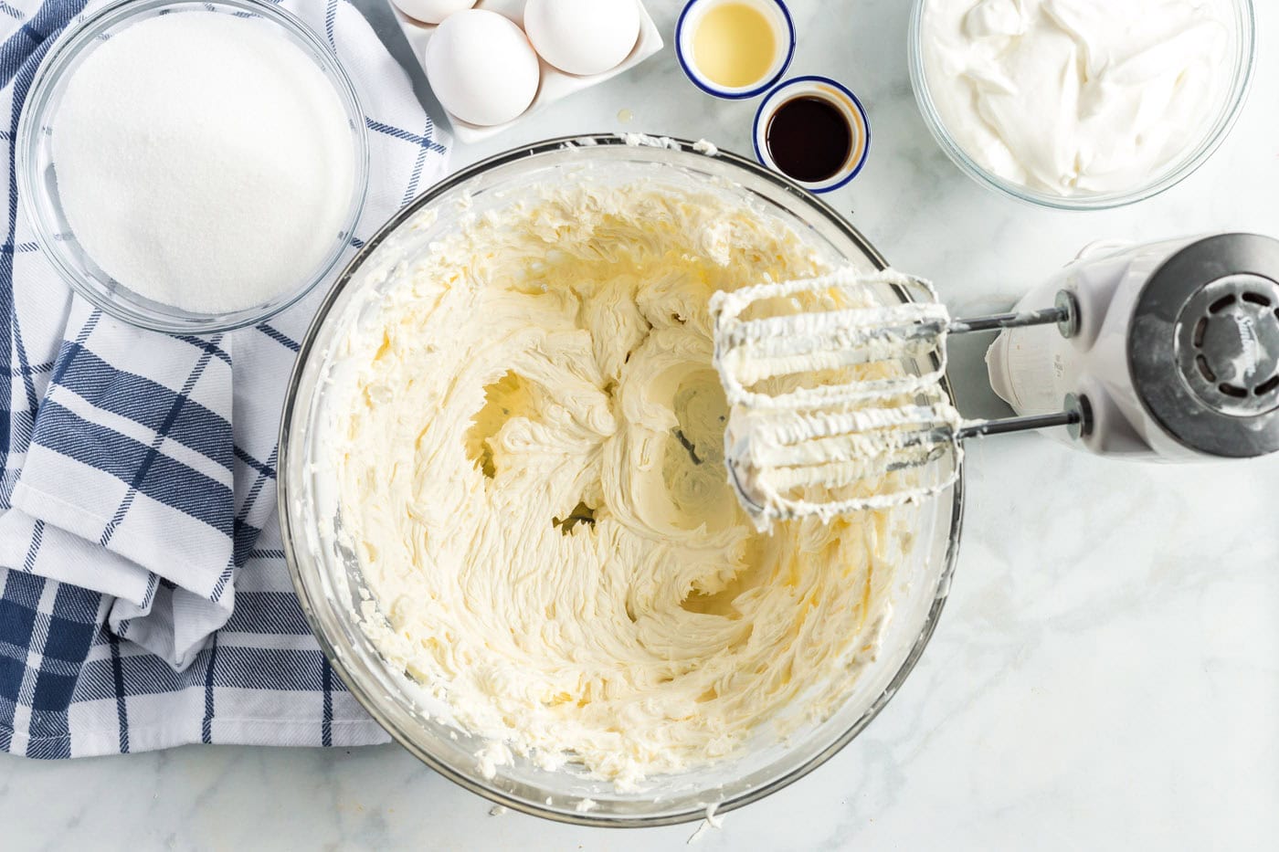 beaters with cream cheese mixture in a bowl