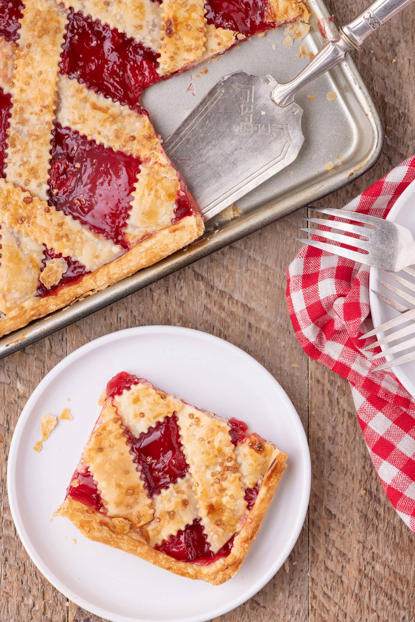 Slice of Cherry Slab Pie on a plate with the slab pie above it