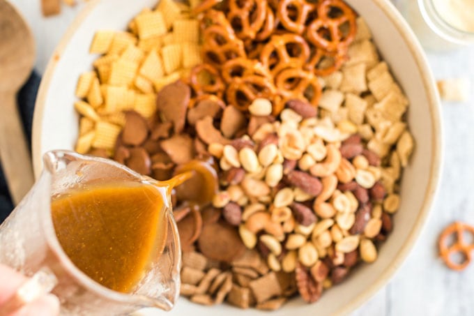 pouring sauce into bowl of snack foods
